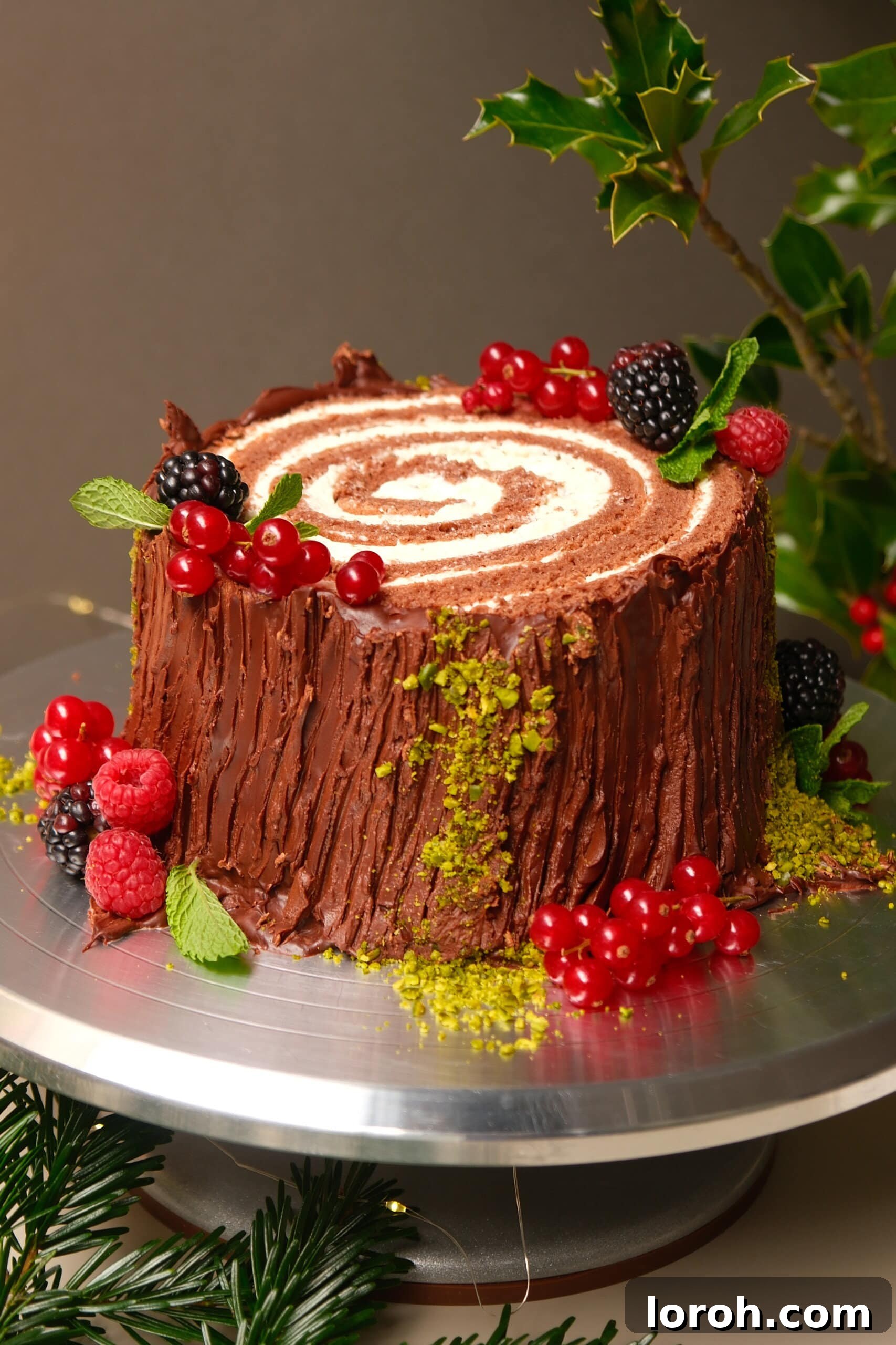 Winter Woodland Roll 5 buche de noel on a plate with berries.