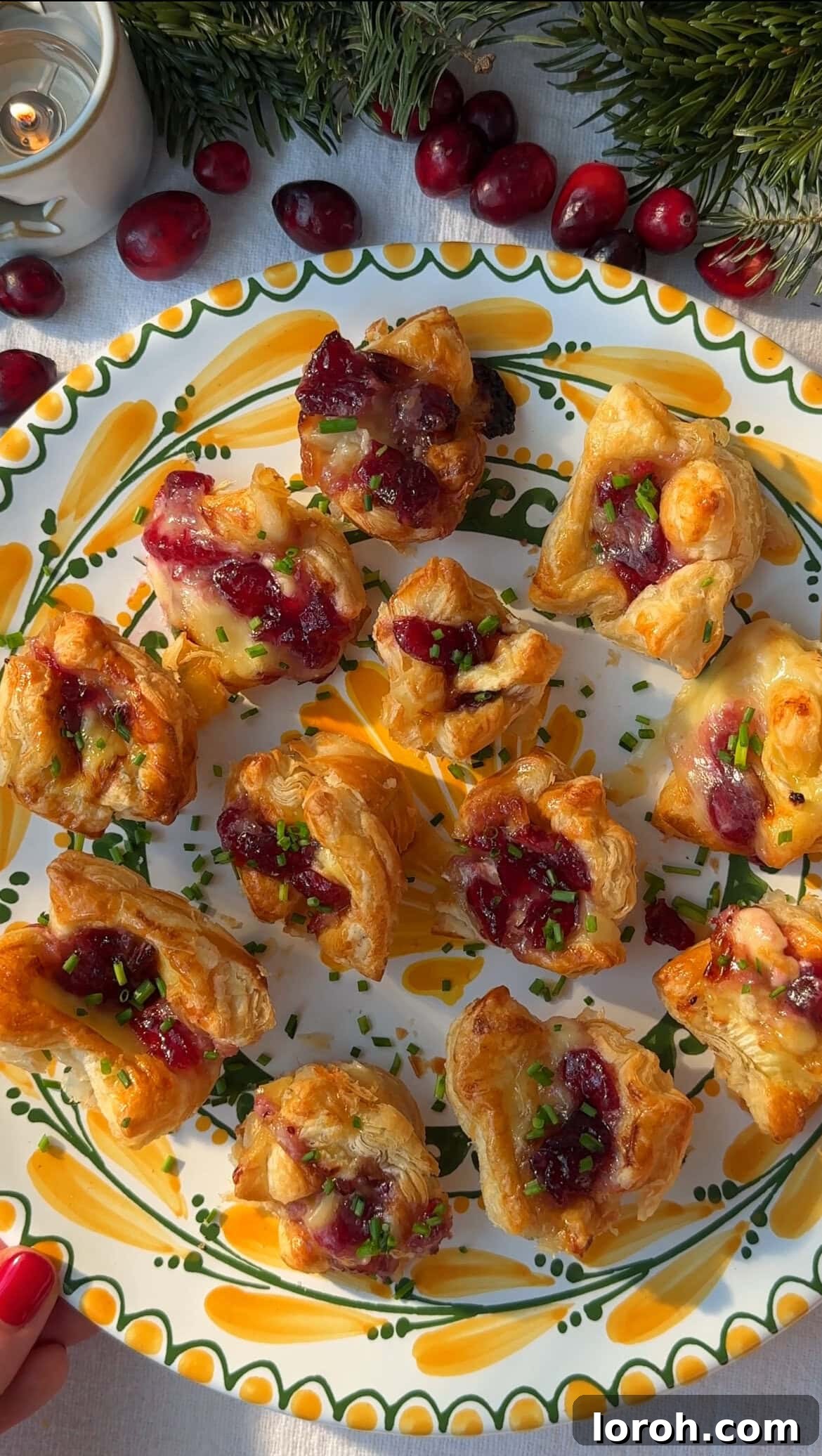 Golden Flaky Brie Bites 10 Baked Brie Puff Pastry Bites garnished with chives in a muffin tin.