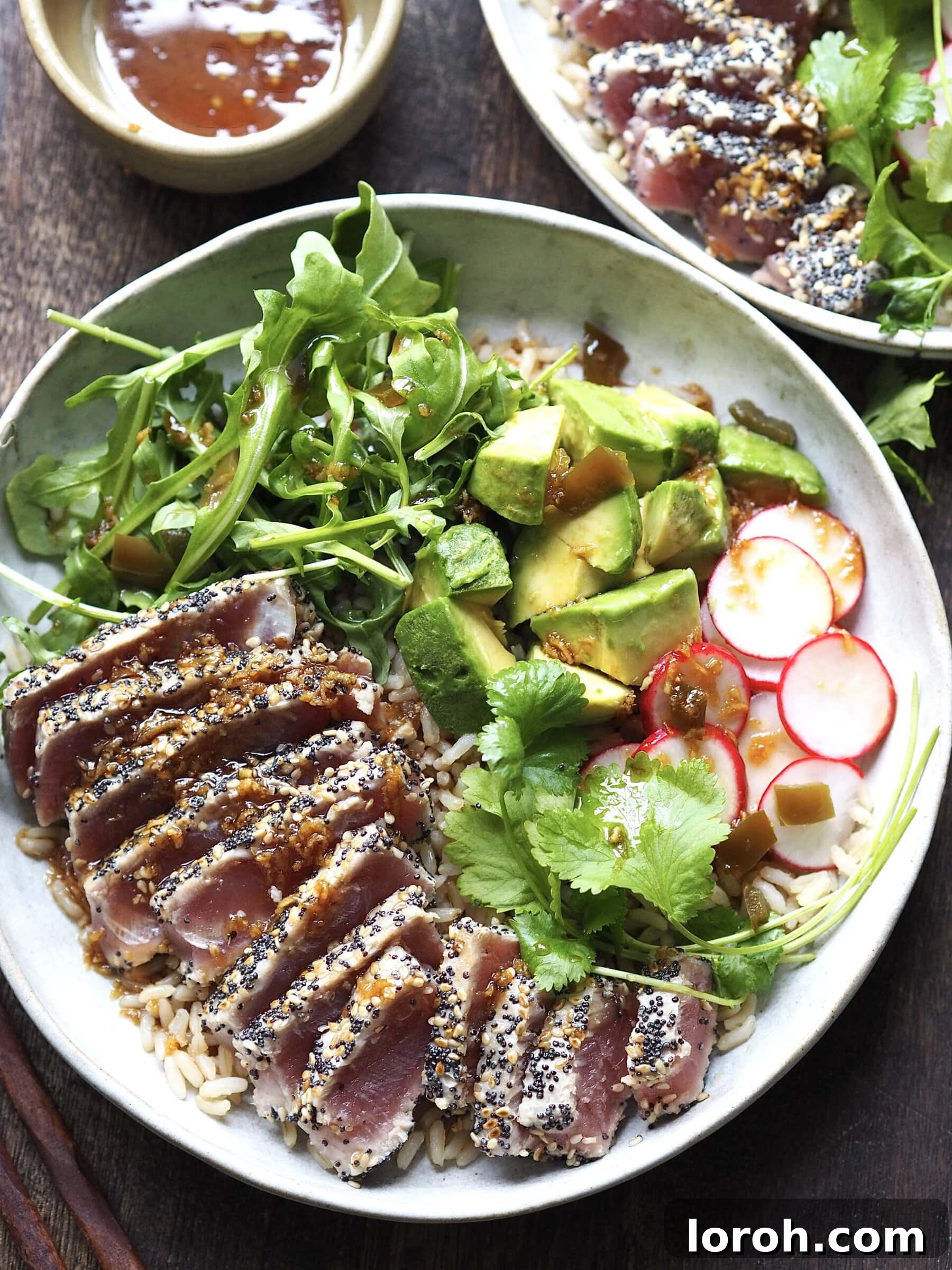 Close-up of a beautifully plated Sesame-Crusted Seared Ahi Tuna Salad, showcasing the vibrant colors and textures of the ingredients.