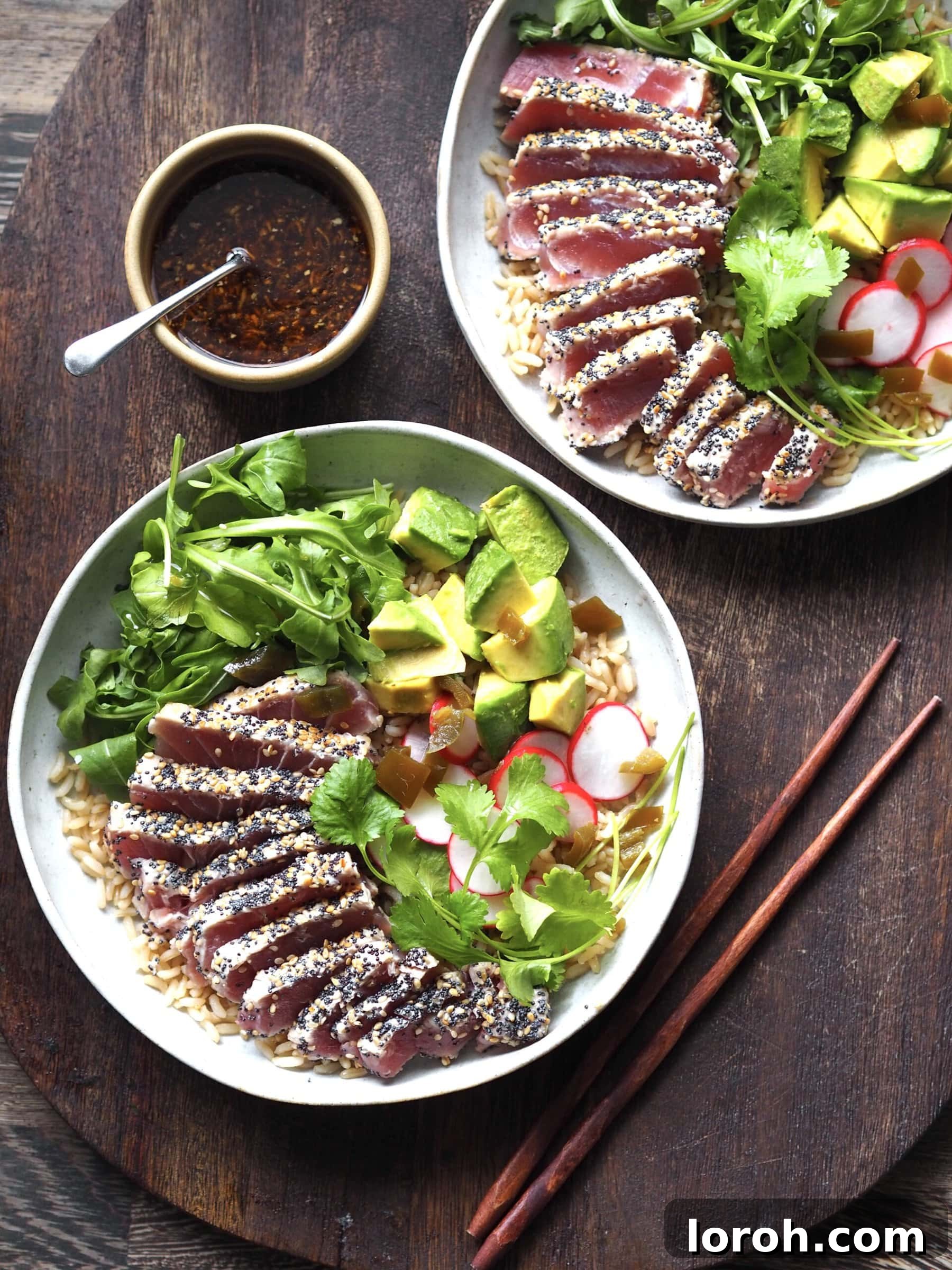 Ahi tuna salad with a small bowl of ginger dressing on the side, ready to be drizzled.