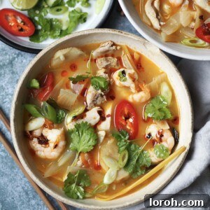 Vibrant Chicken and Prawn Tom Yum Soup 10 A visually stunning bowl of chicken and prawn tom yum soup, beautifully garnished, ready to be served.