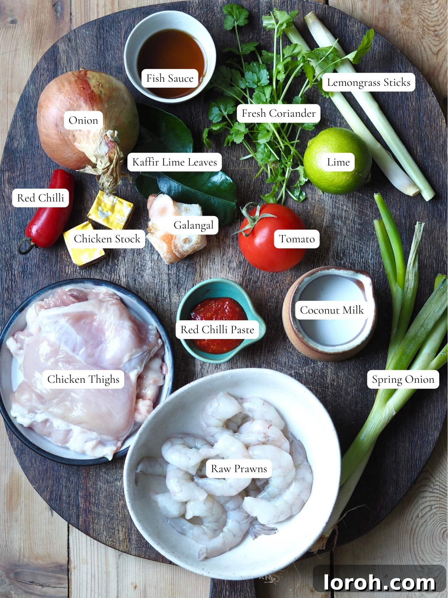 Vibrant Chicken and Prawn Tom Yum Soup 4 A selection of fresh ingredients neatly arranged, including lemongrass, galangal, kaffir lime leaves, chili, and tomato, ready for making tom yum soup.