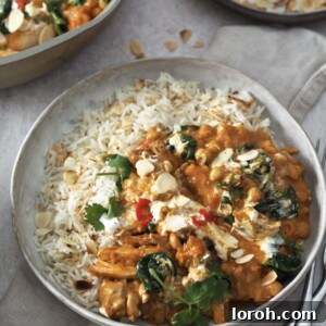 Golden Chicken & Chickpea Curry 11 chicken and chickpea curry garnished with yoghurt and herbs served with rice.