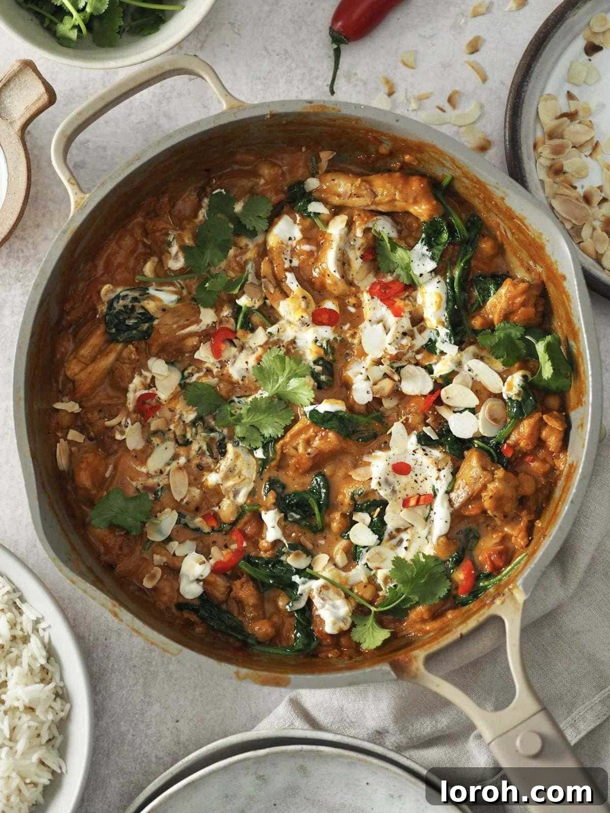 Golden Chicken & Chickpea Curry 4 chicken and chickpea curry garnished with yoghurt and herbs.