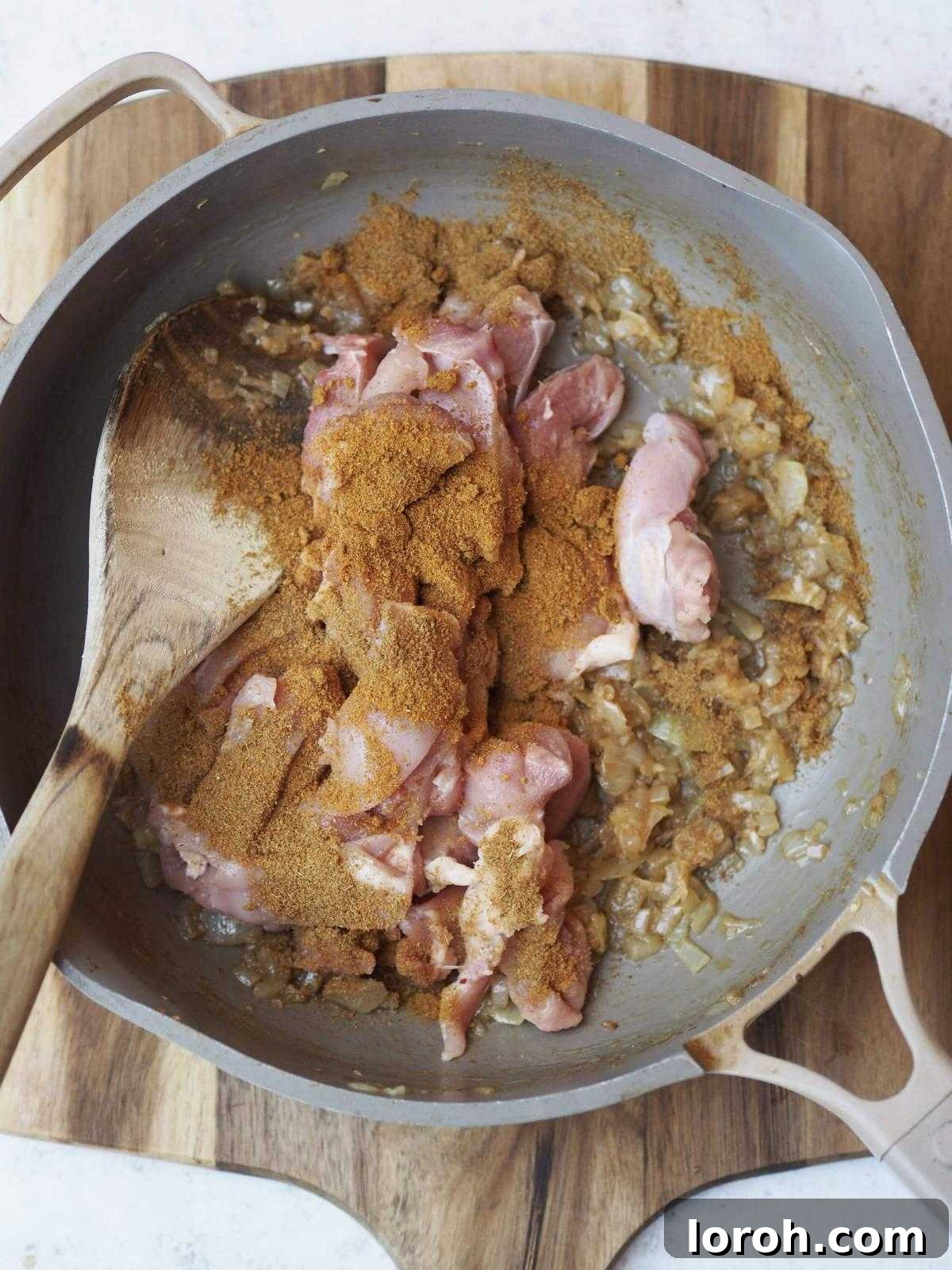 Golden Chicken & Chickpea Curry 6 frying chicken with spices and onions.