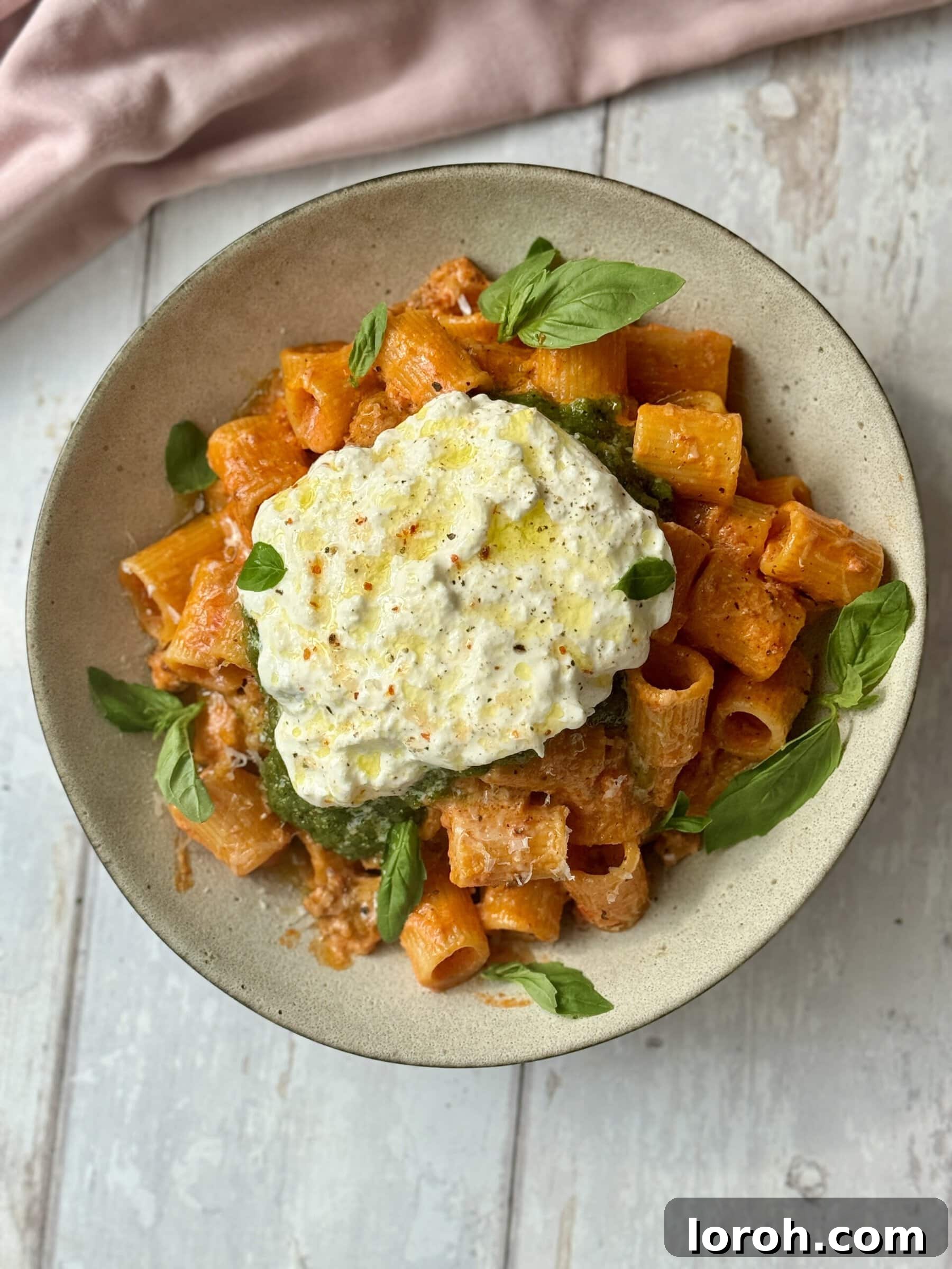 Velvet Vodka Chicken Pasta 2 Chicken and vodka pasta scooped into a bowl with pesto and burrata on top, ready to serve.
