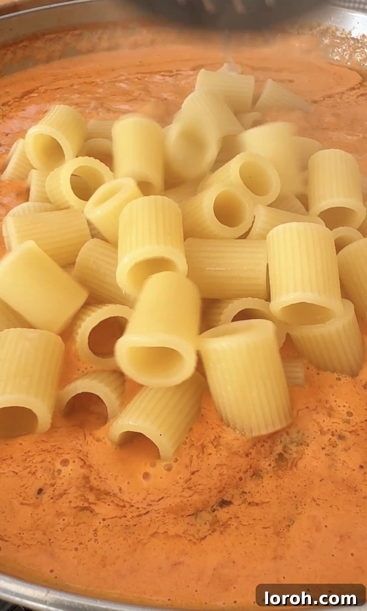 Velvet Vodka Chicken Pasta 11 Tossing drained pasta with the chicken and vodka sauce, incorporating grated Parmesan.