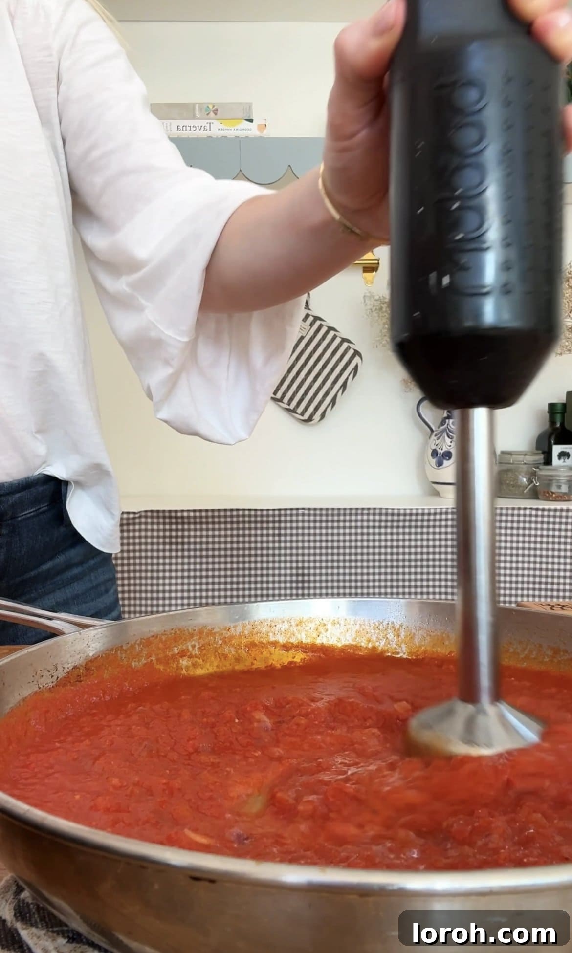 Velvet Vodka Chicken Pasta 8 Blending the vodka sauce until smooth and creamy for a refined texture.