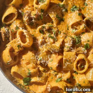 Prawn and chorizo pasta in a stainless steel pan.