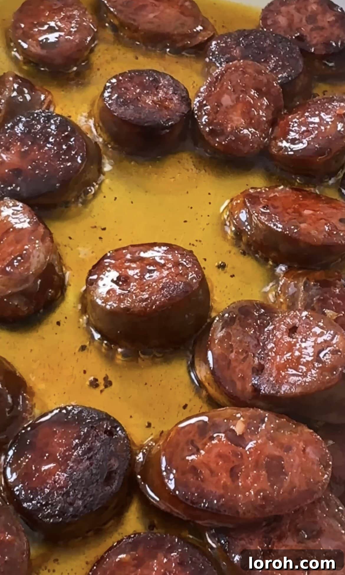 Smoky Chorizo Prawn Pasta 4 Sizzling chorizo slices frying in a pan, releasing their vibrant red oil.