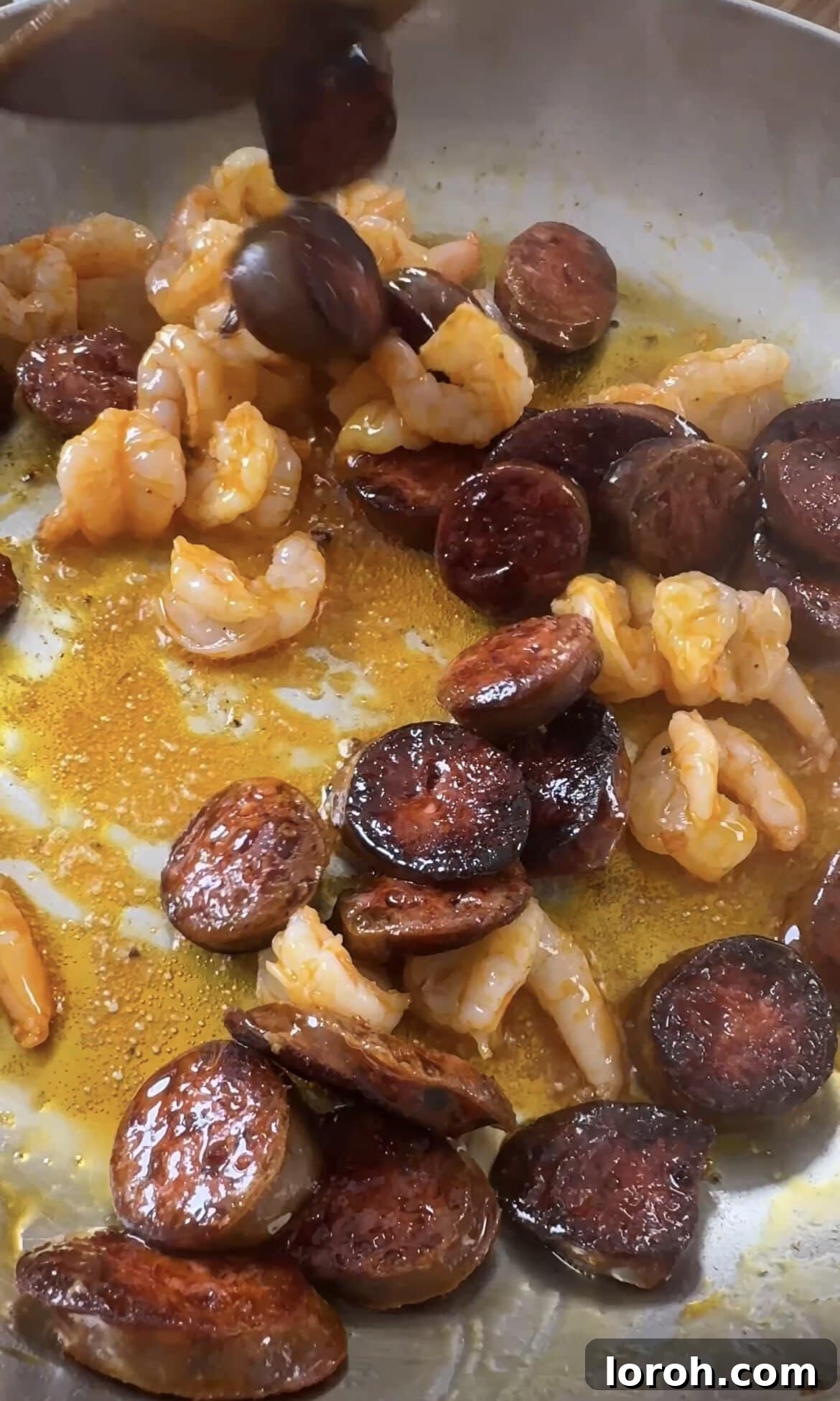 Smoky Chorizo Prawn Pasta 5 Prawns cooking alongside golden chorizo in a hot pan, turning pink.