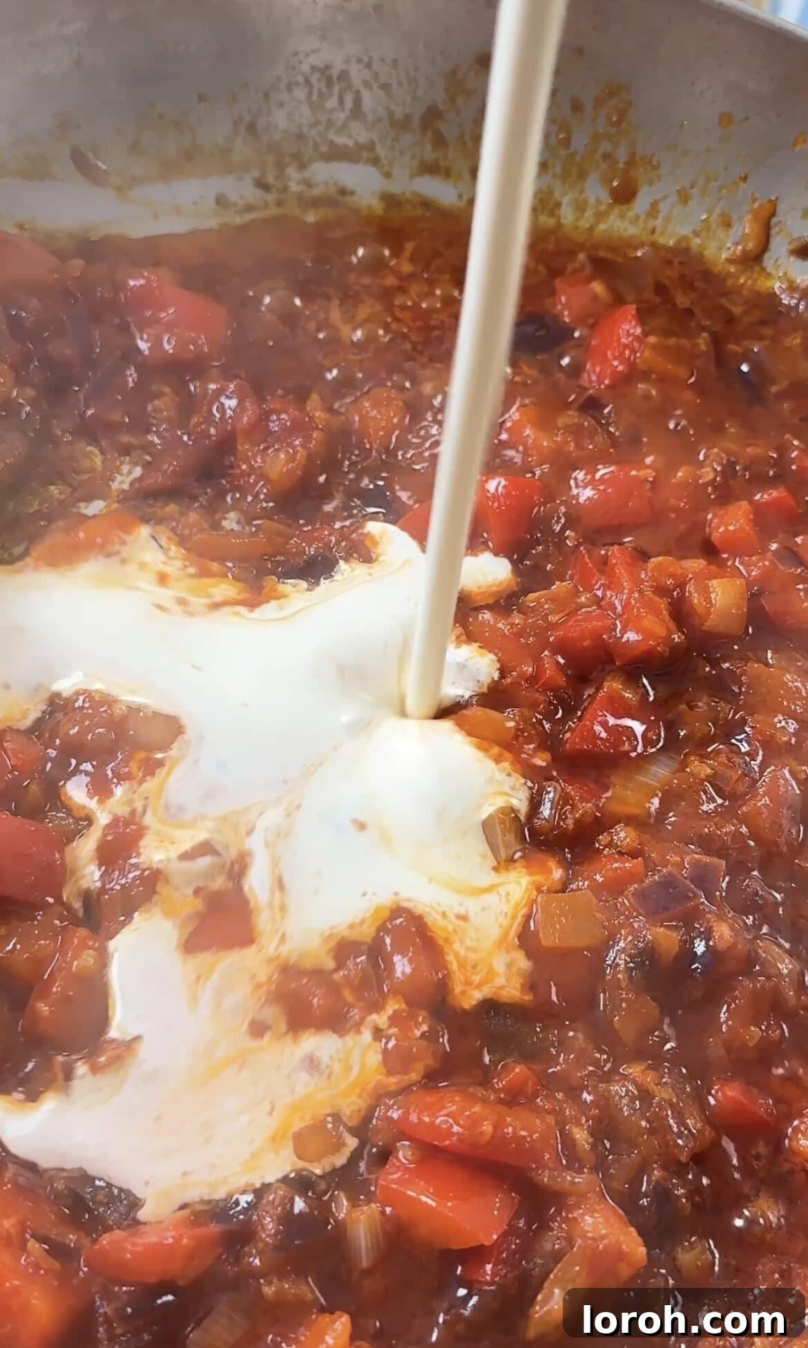 Smoky Chorizo Prawn Pasta 8 Pouring fresh cream into the bubbling tomato and vegetable sauce.