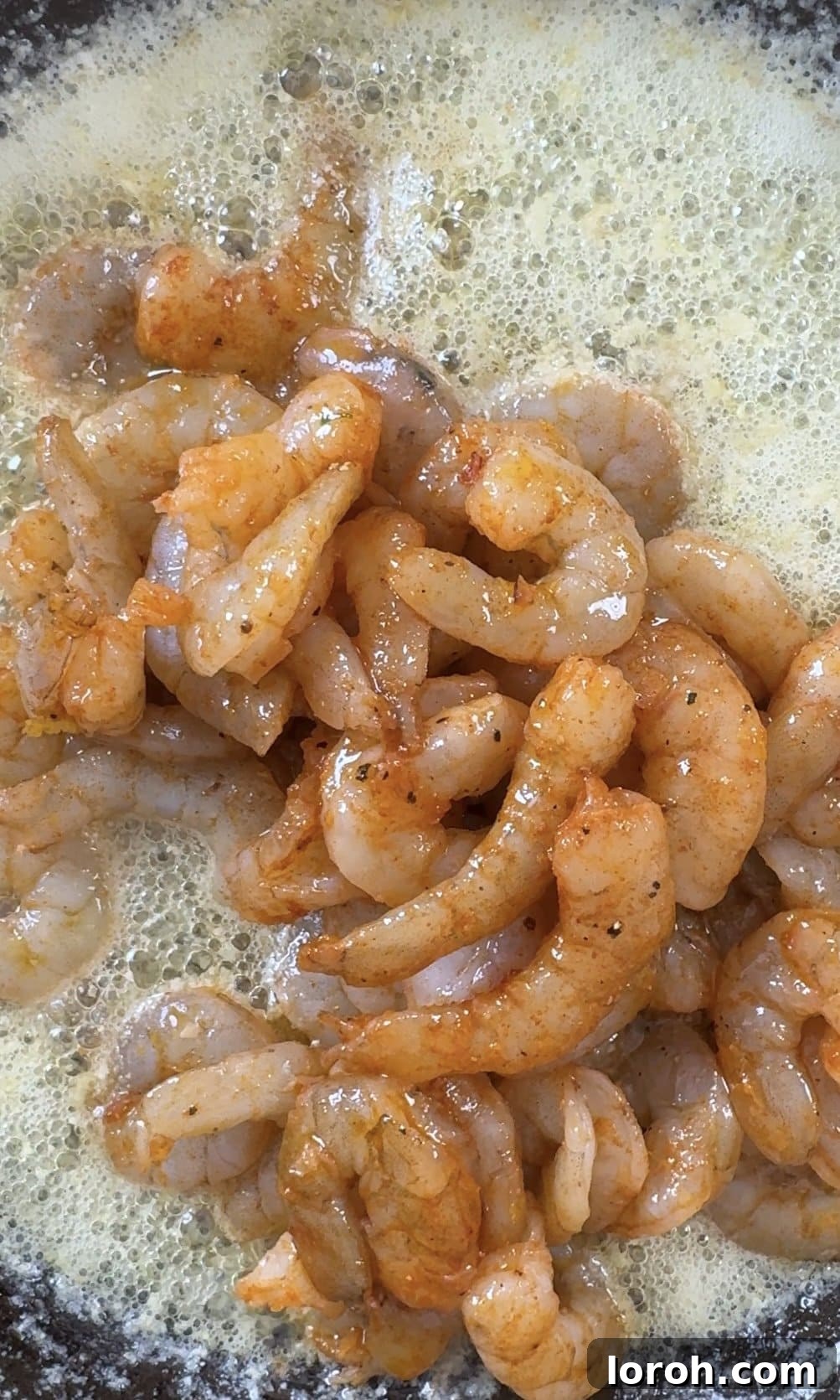 Sizzling Garlic Butter Prawns 8 adding prawns to the butter in the pan.