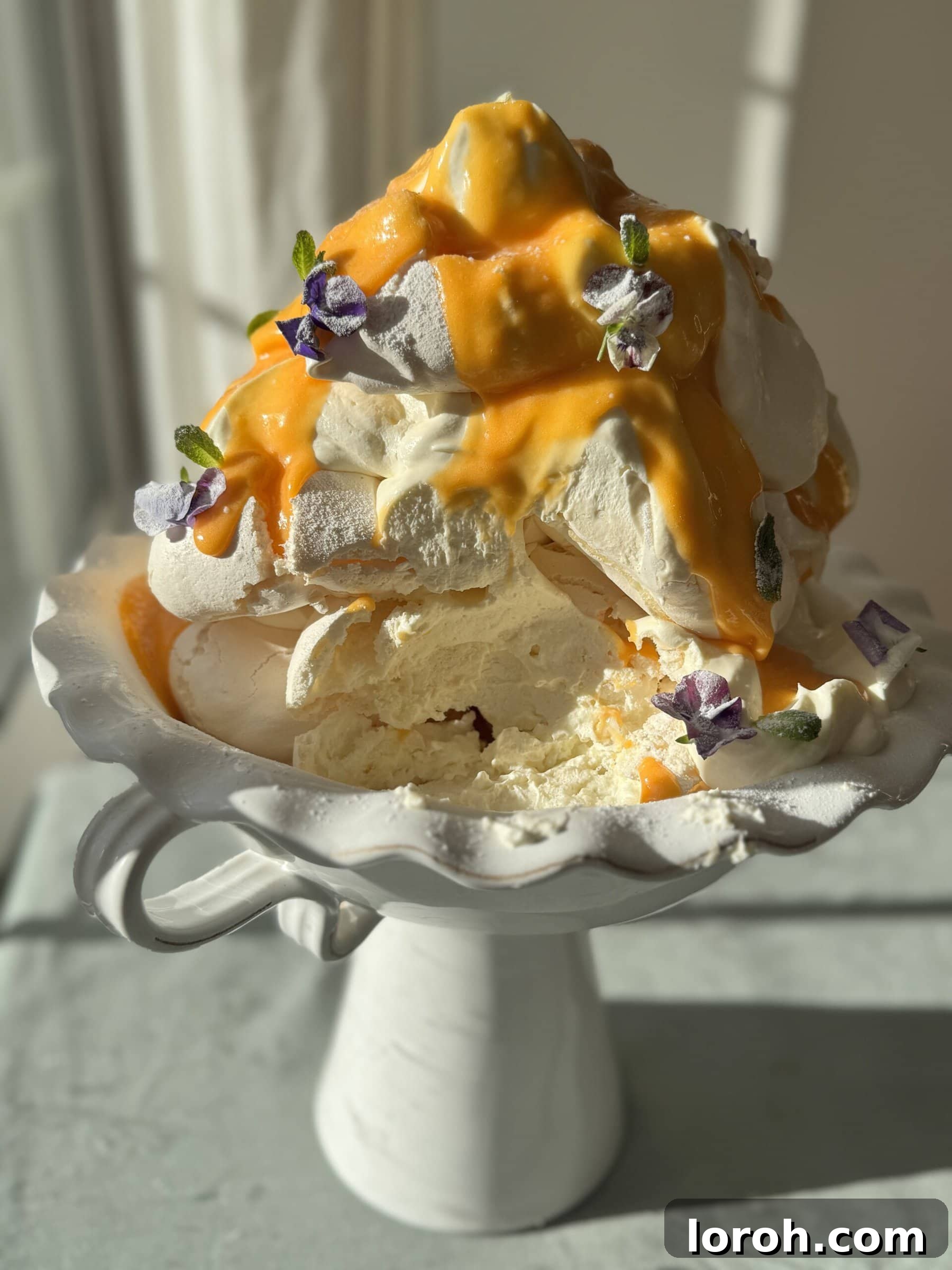 A beautifully arranged tower of lemon meringues with lemon curd, fresh berries, and delicate edible flowers, perfect for a grand dessert presentation.