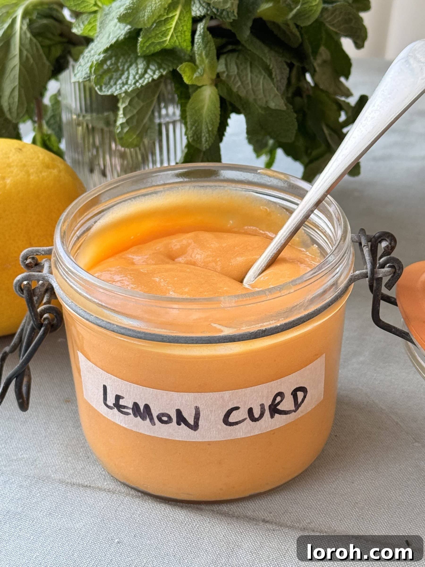 A beautiful jar of vibrant homemade lemon curd, ready to be enjoyed as a versatile culinary ingredient or a simple spread.