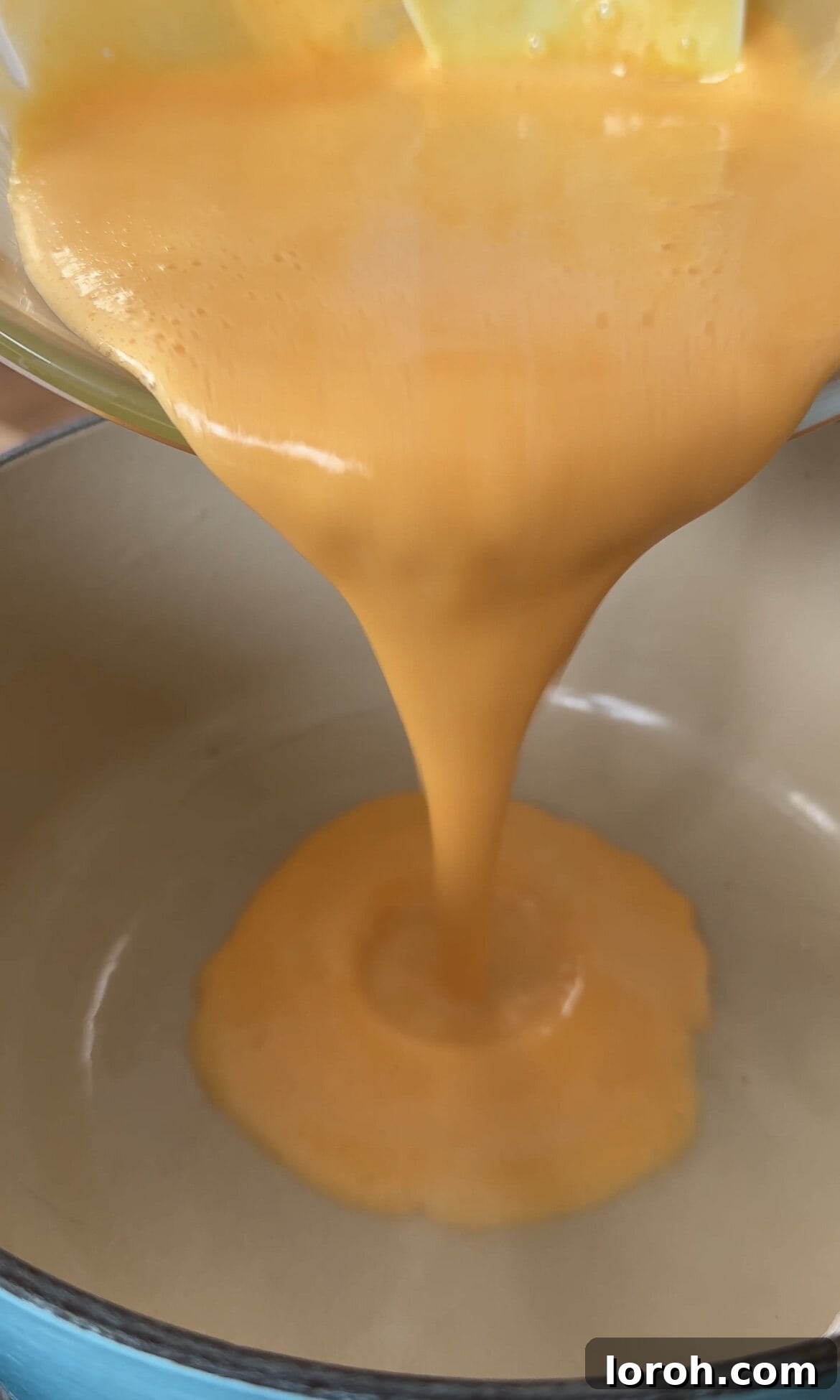 Returning the lemon-egg mixture to the saucepan and cooking over low heat, stirring continuously.