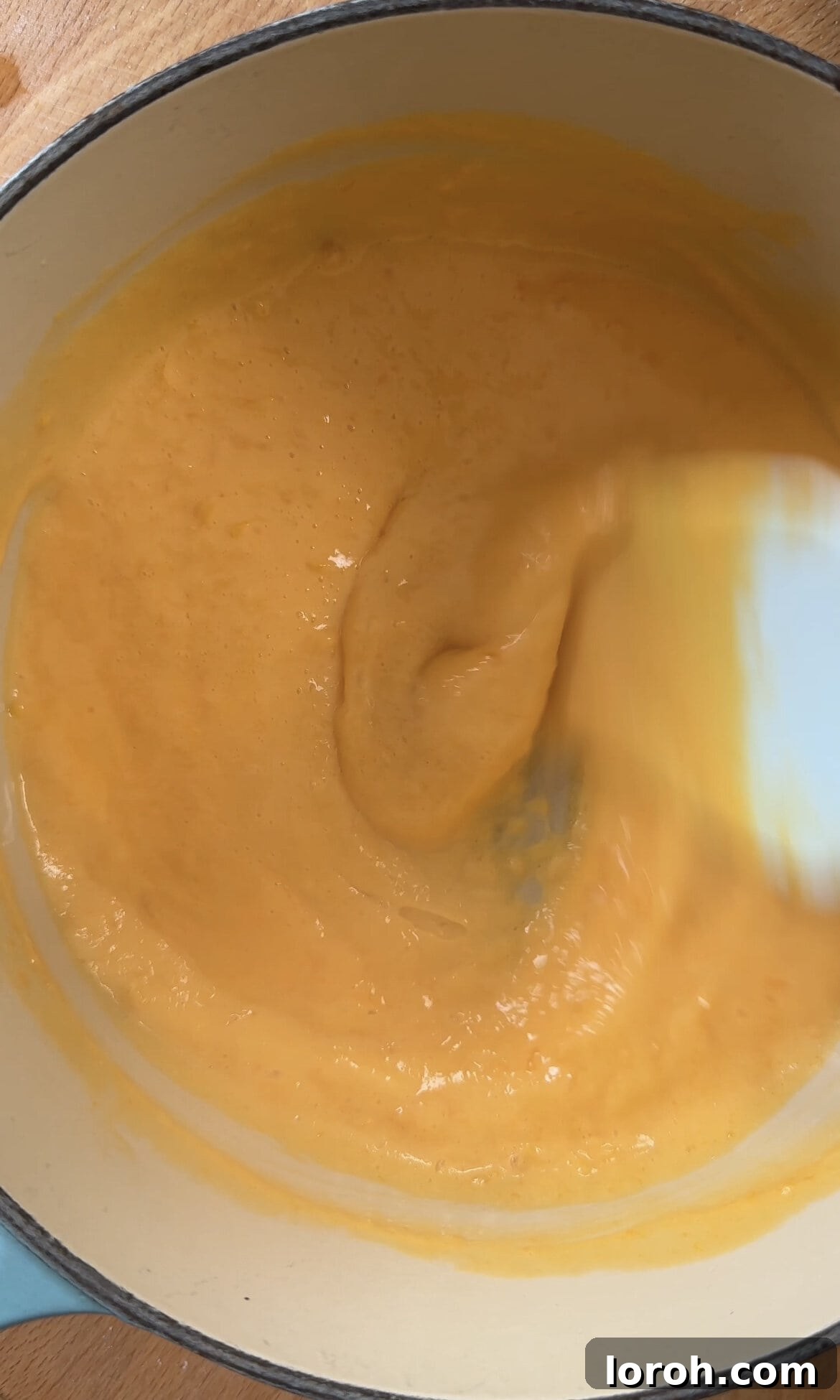 Mixing the thickening easy lemon curd constantly over low heat to ensure even cooking and prevent scrambling.