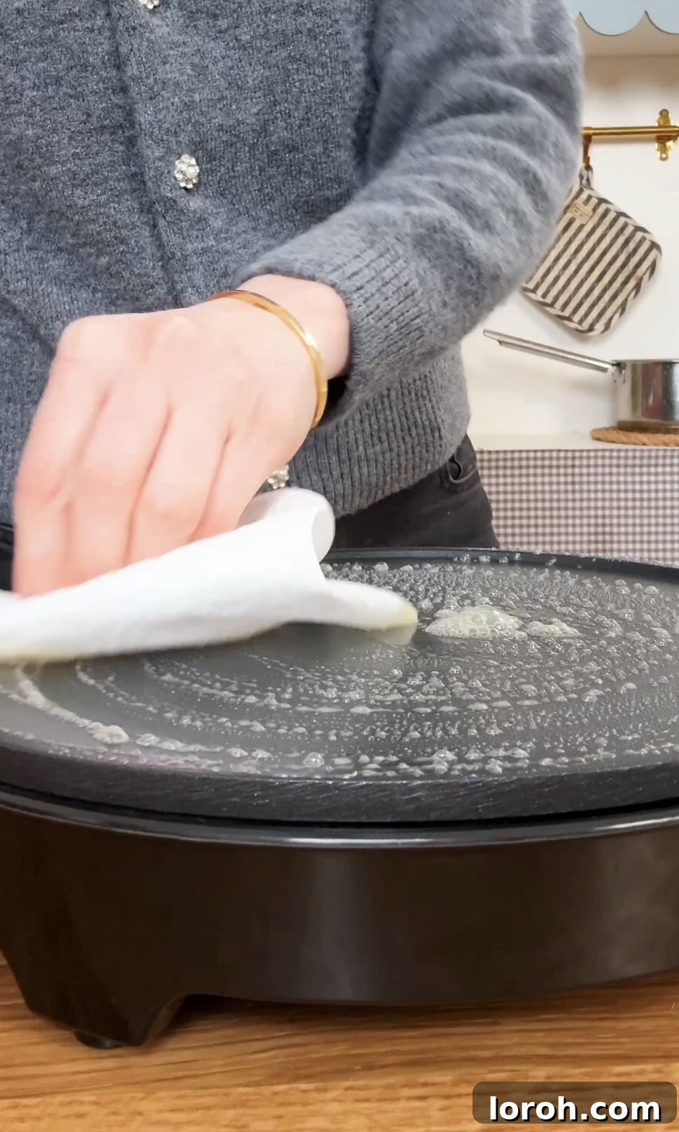 Golden Banana Crêpes 6 Melting a knob of butter in a nonstick pan, preparing it for crepe cooking.