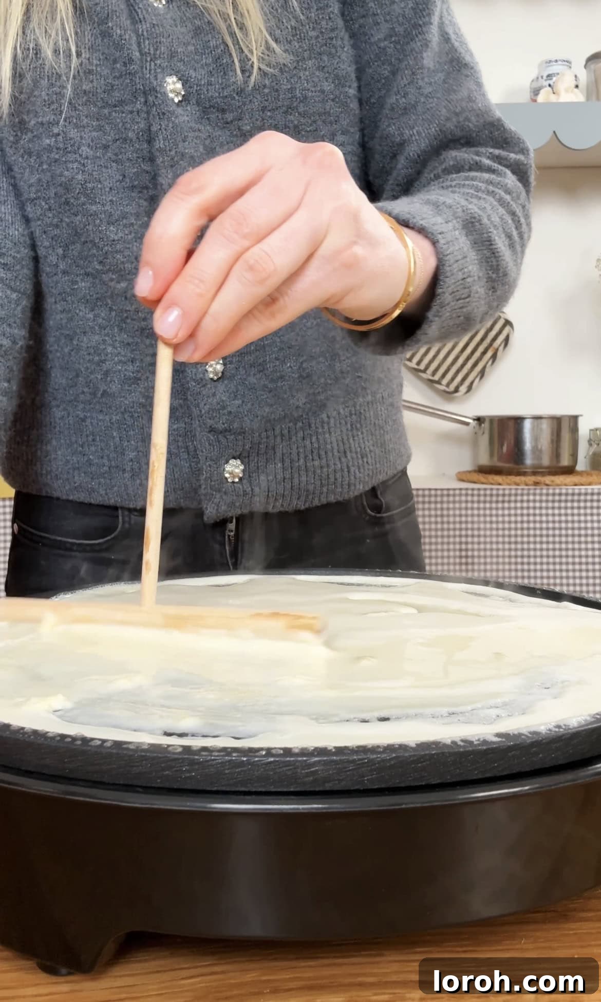 Golden Banana Crêpes 8 Skillfully spreading thin crepe batter across the pan for an even, delicate layer.
