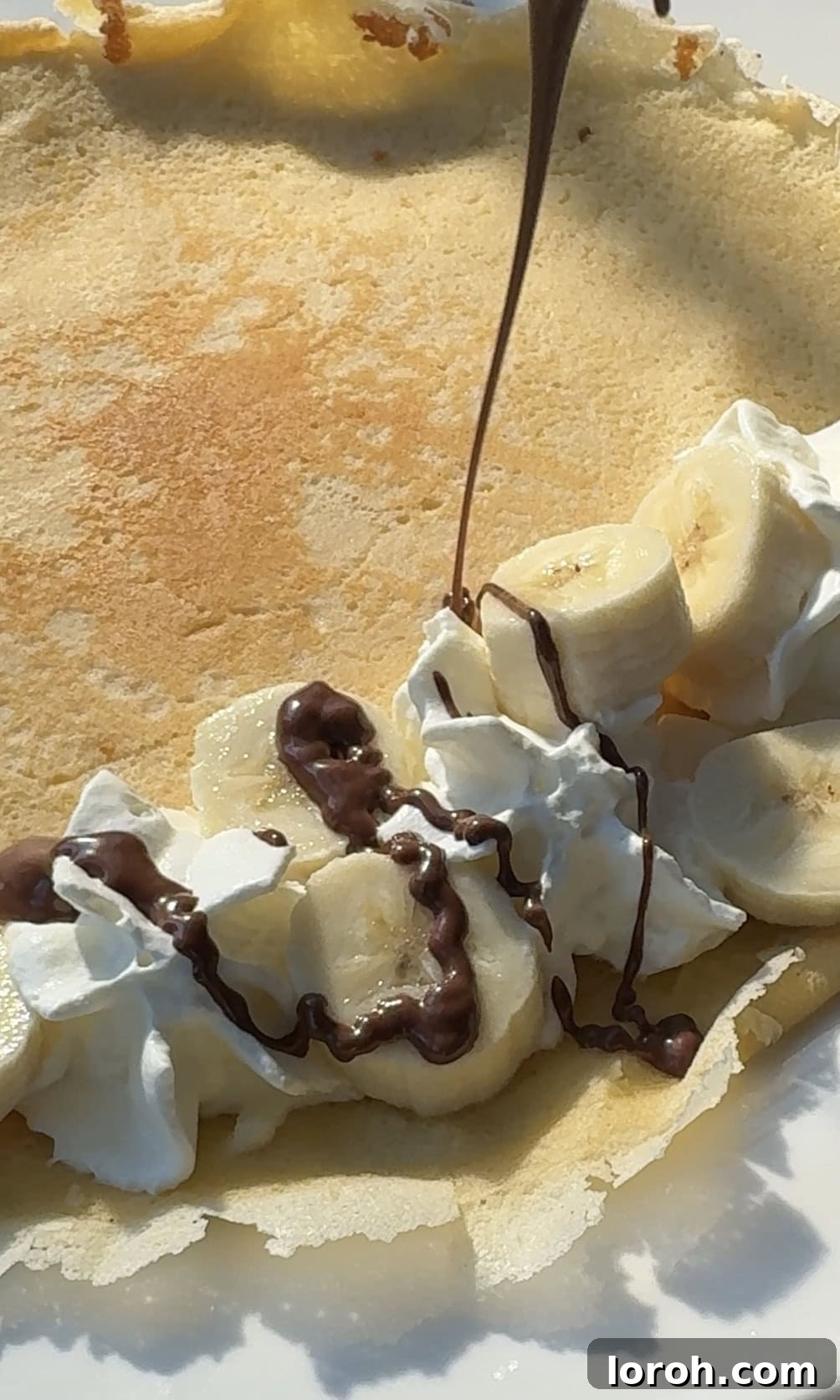 Golden Banana Crêpes 10 Adding luscious whipped cream, sweet banana slices, and a rich drizzle of melted Nutella to a freshly cooked crepe.