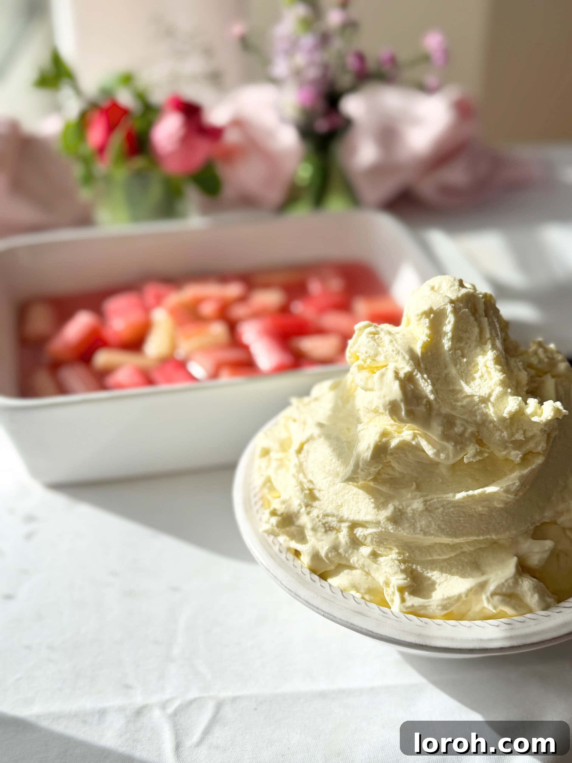 whipped mascarpone cream in a bowl, served with poached rhubarb, showcasing its versatility.