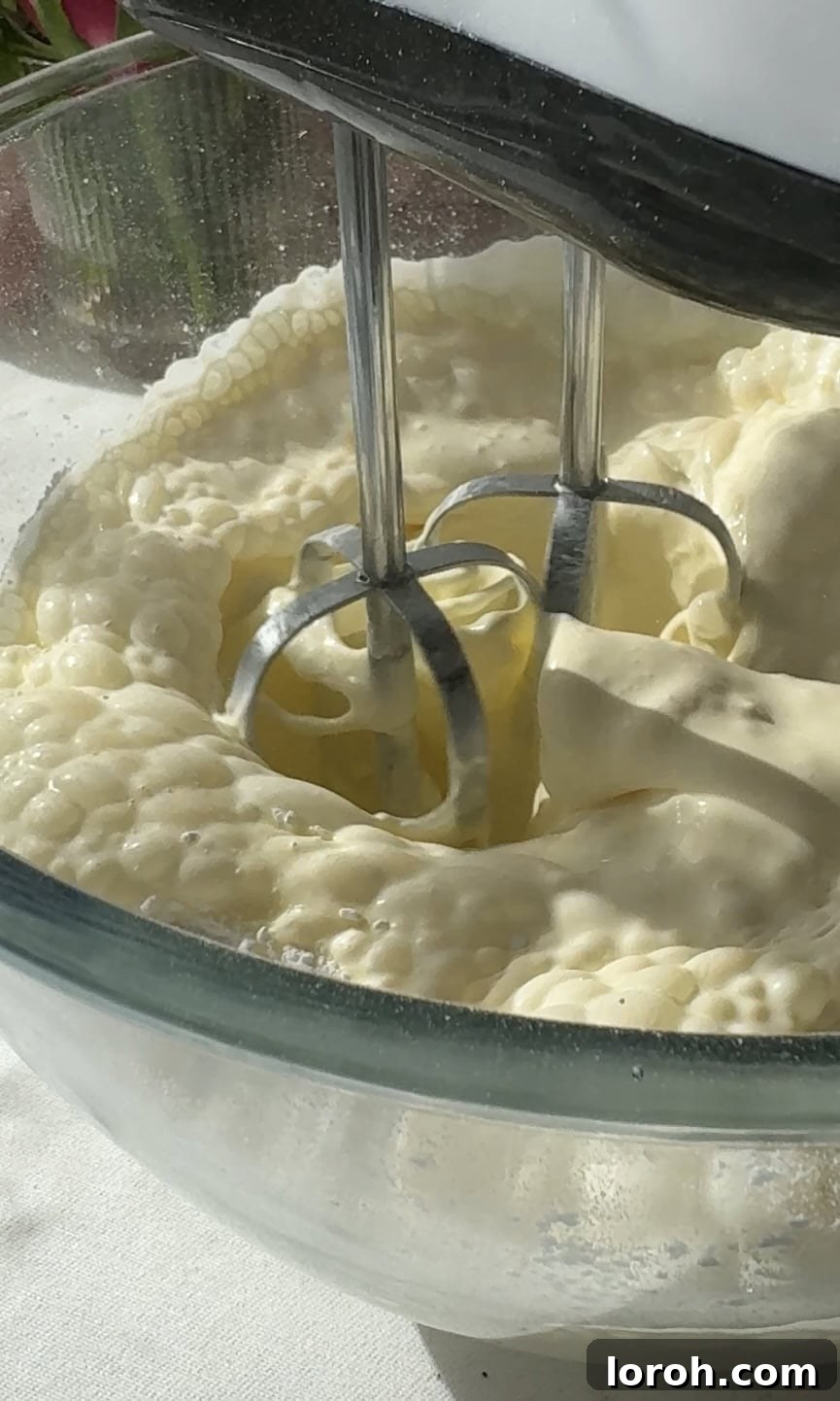 whipping double cream until soft peaks form.