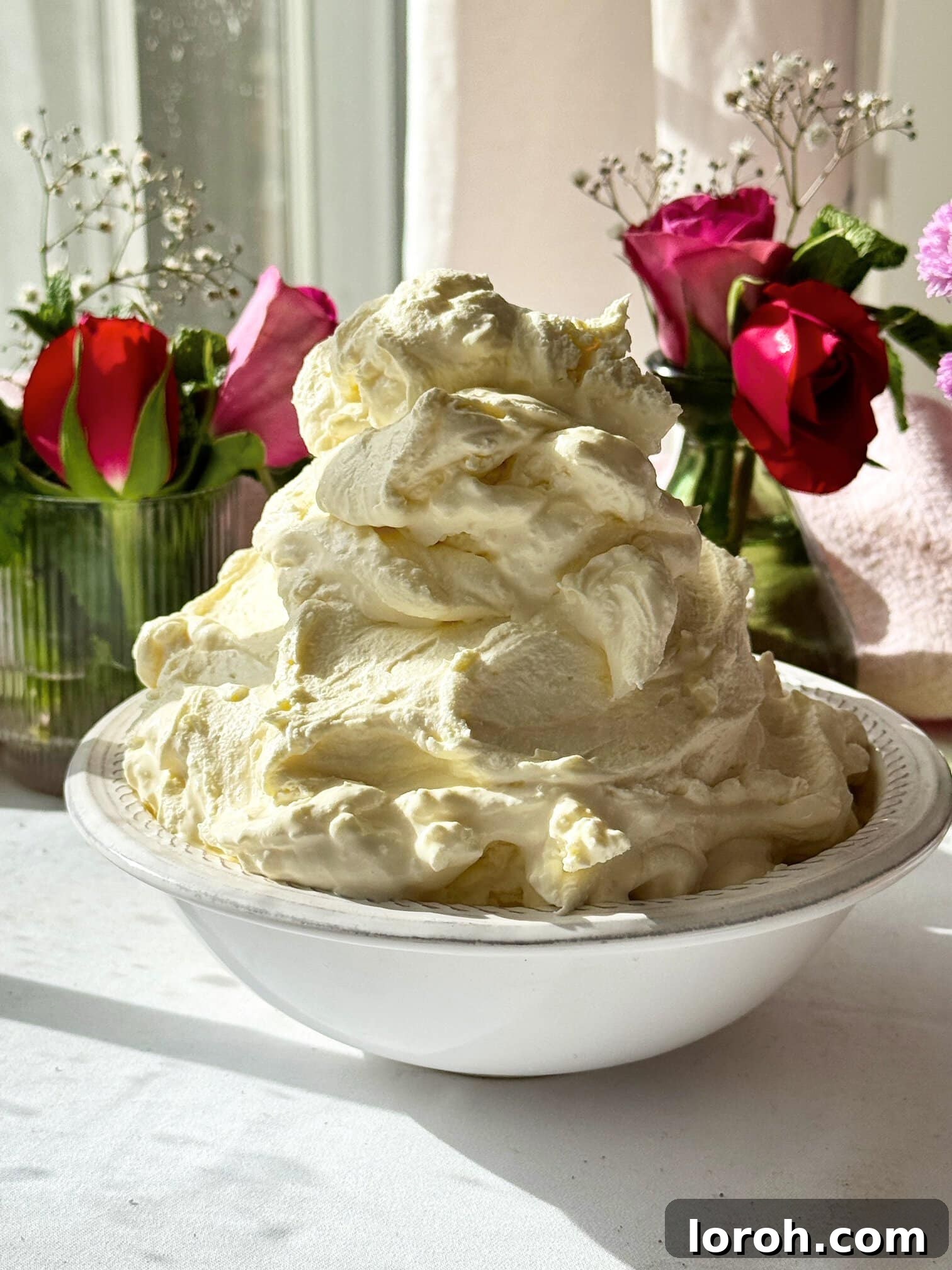 whipped mascarpone cream in a bowl, showing its light and airy texture.