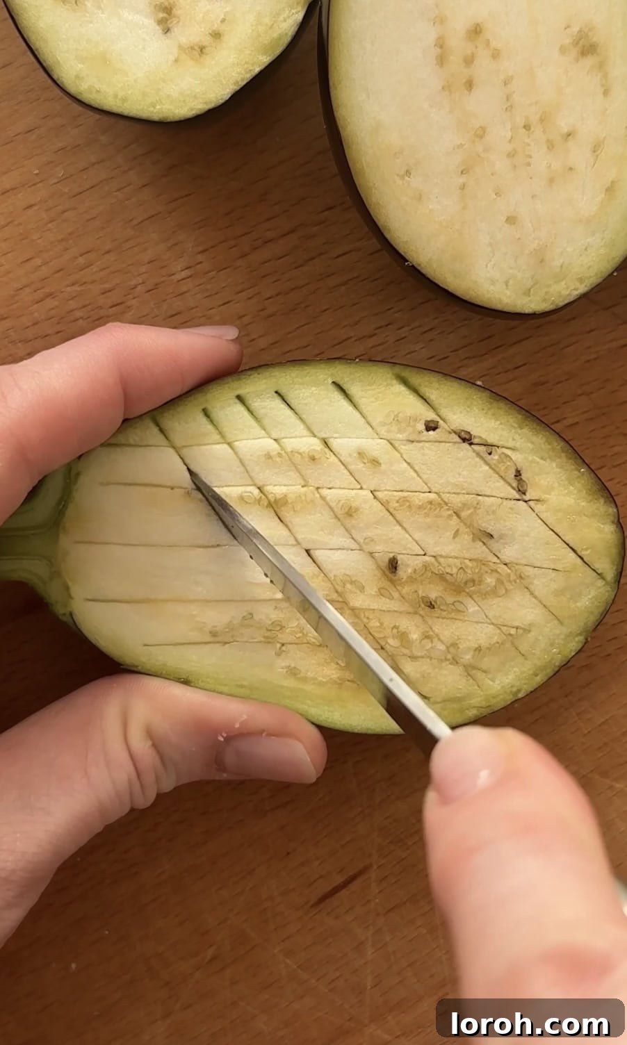 Cross-hatching the aubergine flesh.