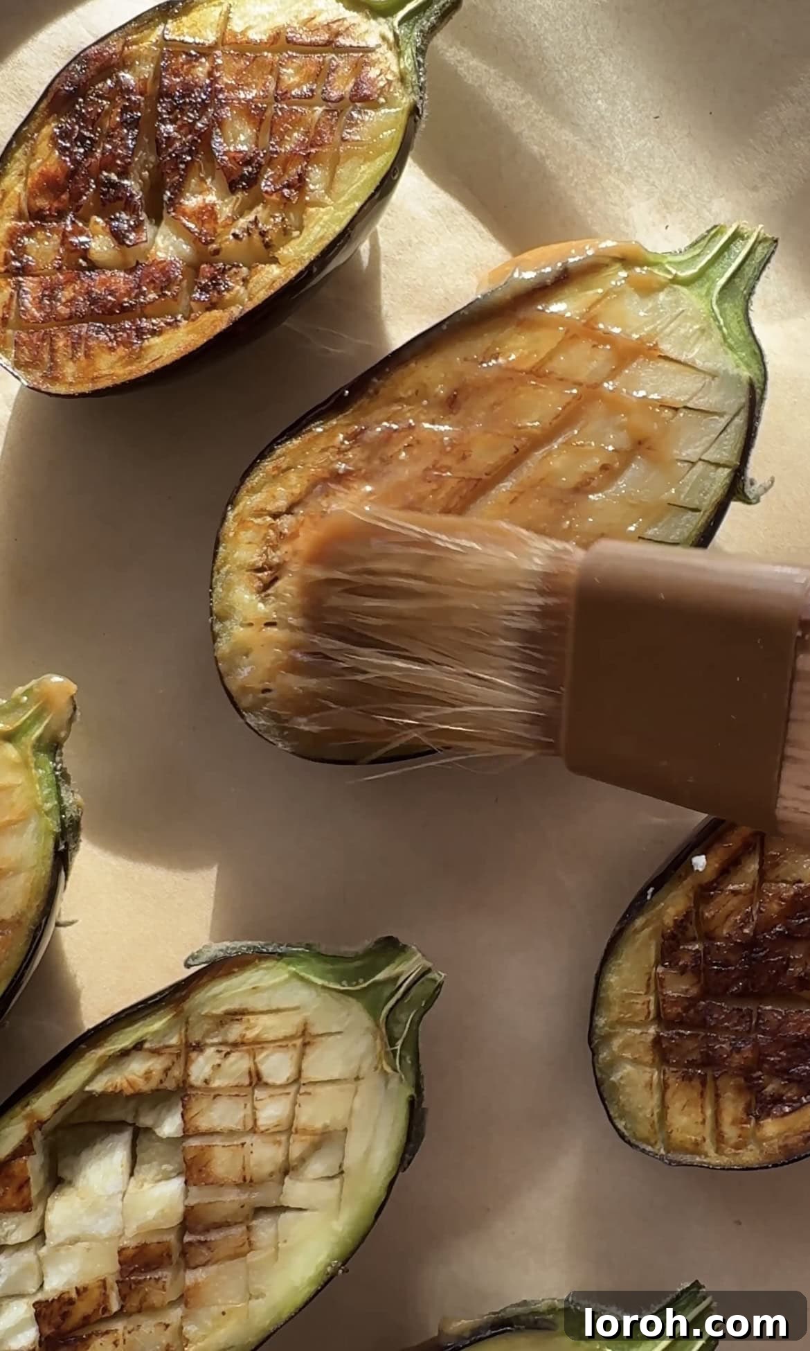 Brushing miso marinade onto pan-fried aubergine.