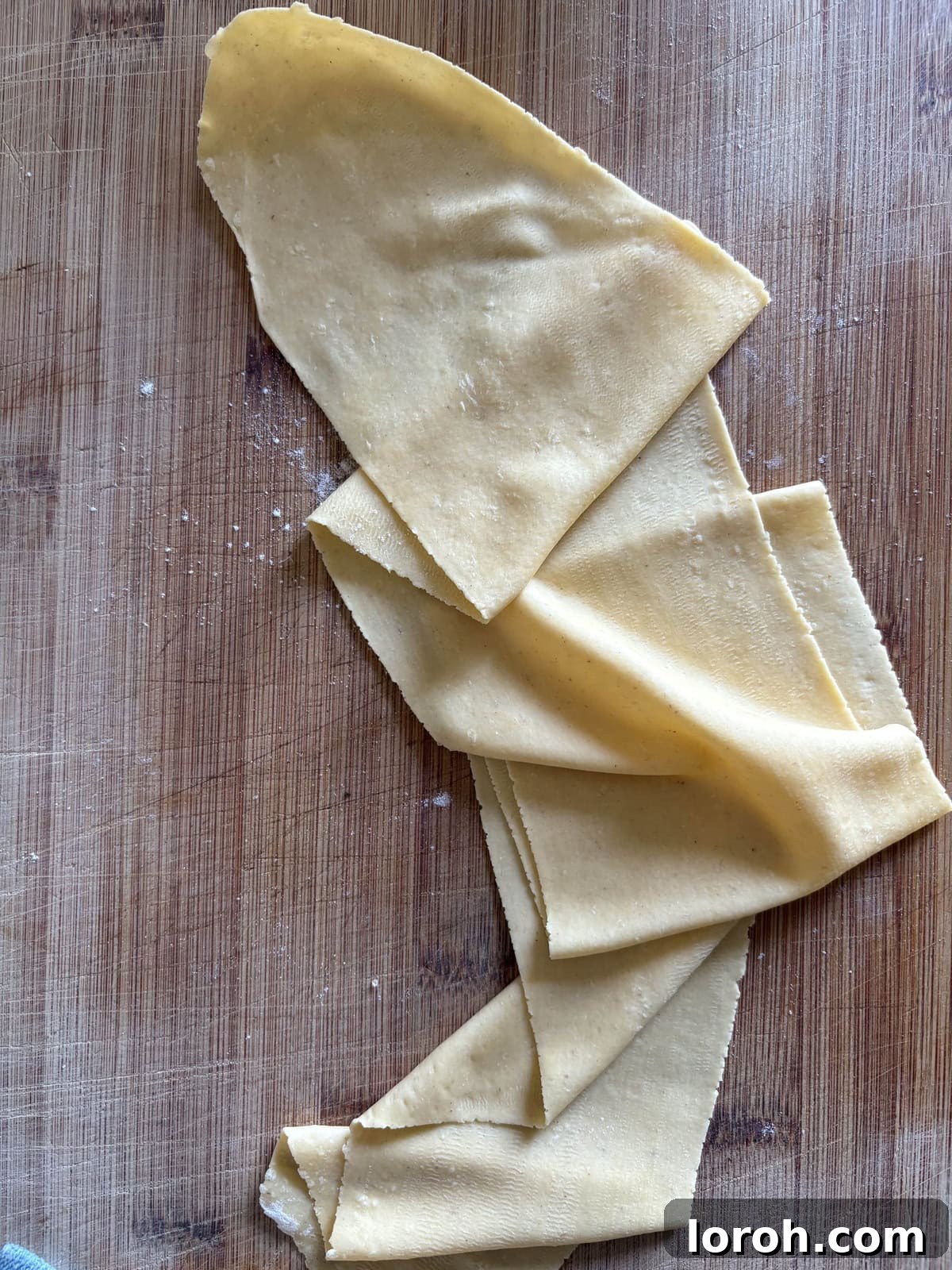 The Art of Homemade Pasta Dough 14 close-up of fresh, hand-shaped pasta drying on a rack.