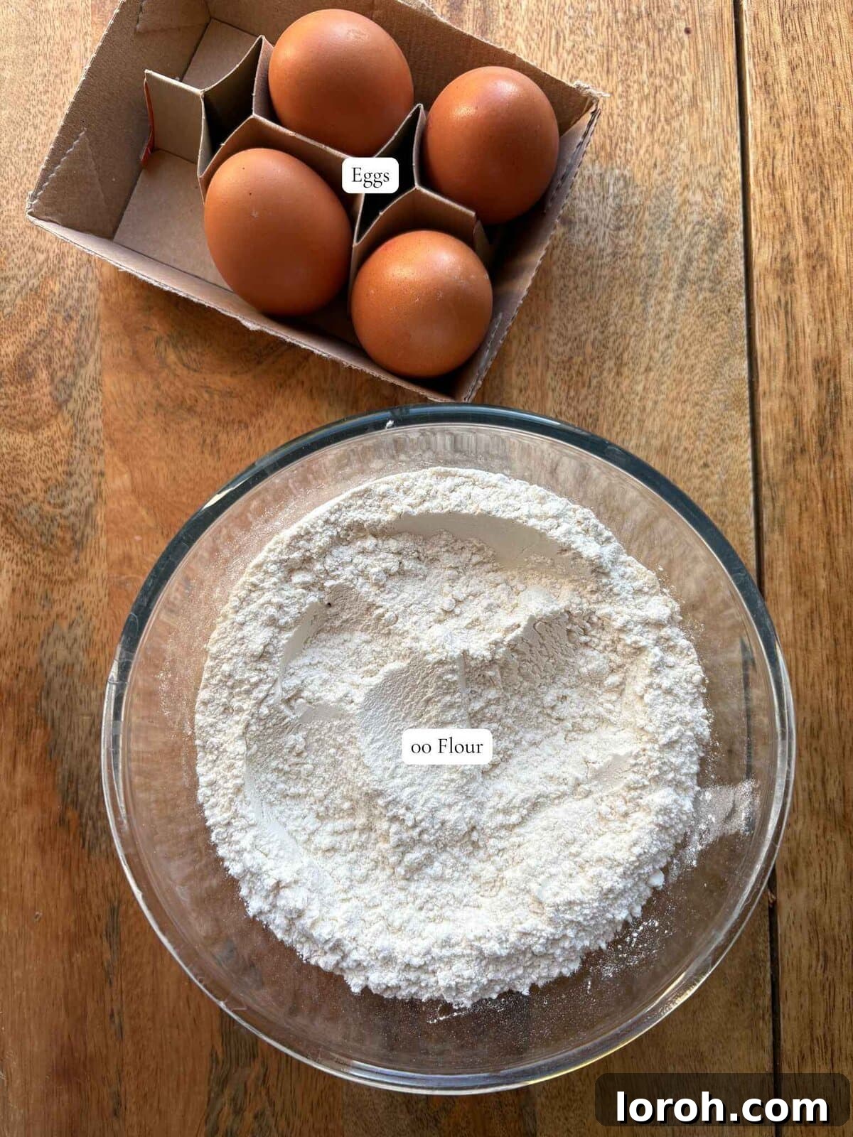 The Art of Homemade Pasta Dough 3 labelled ingredients including 00 flour, semolina flour, and eggs for making pasta dough.