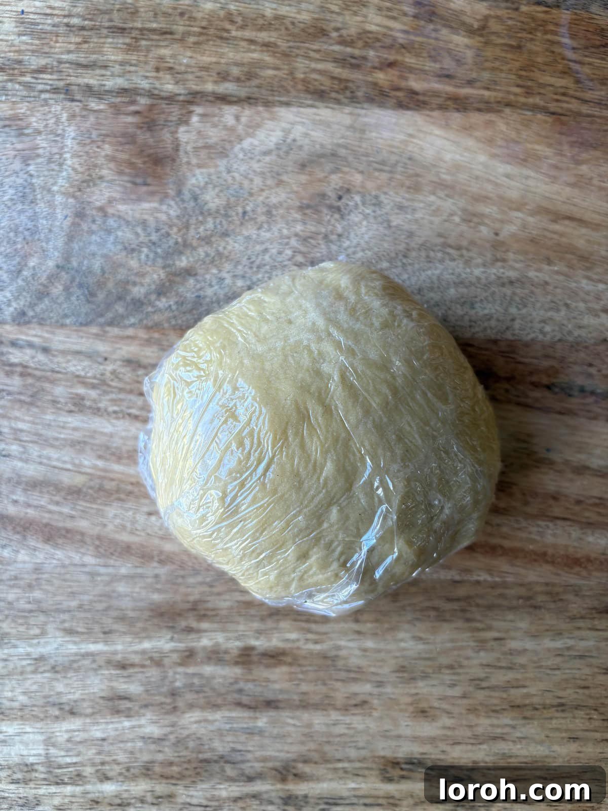 The Art of Homemade Pasta Dough 9 wrapping pasta dough in cling film for resting.