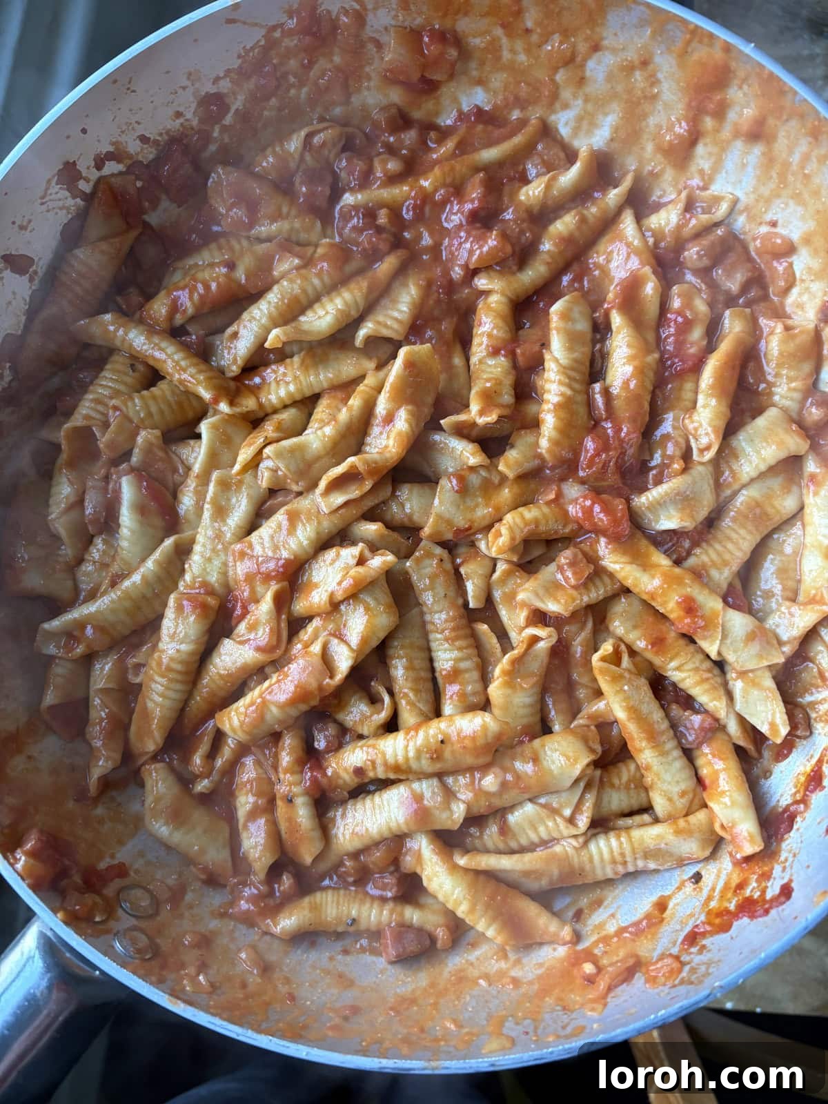 Close-up of freshly rolled garganelli on a tray.