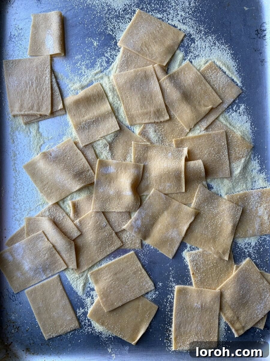 Garganelli pasta dough cut into squares.