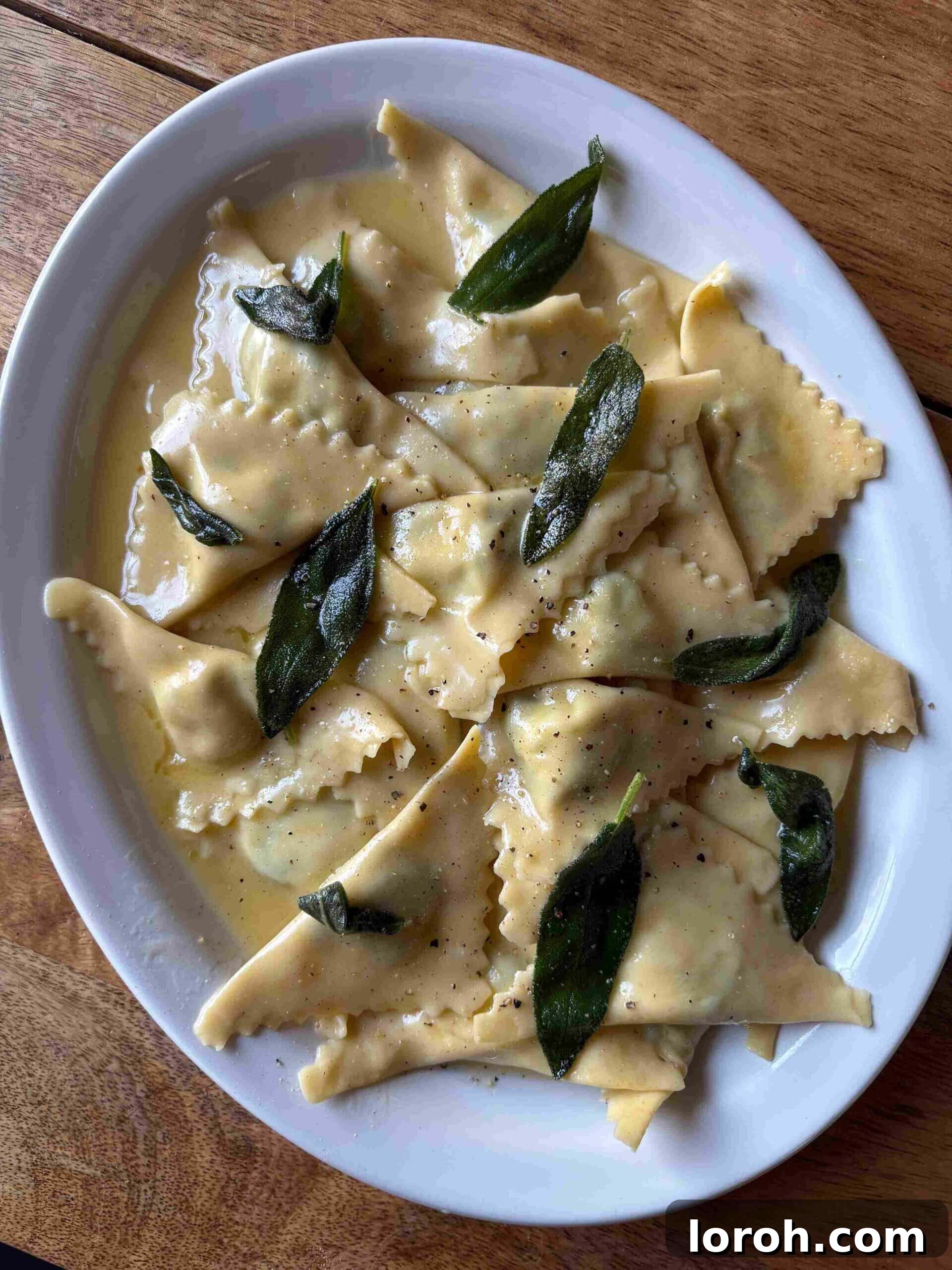 Crafting Delicious Triangoli Pasta From Scratch 4 Triangoli filled with spinach and ricotta in butter sauce, ready to serve.