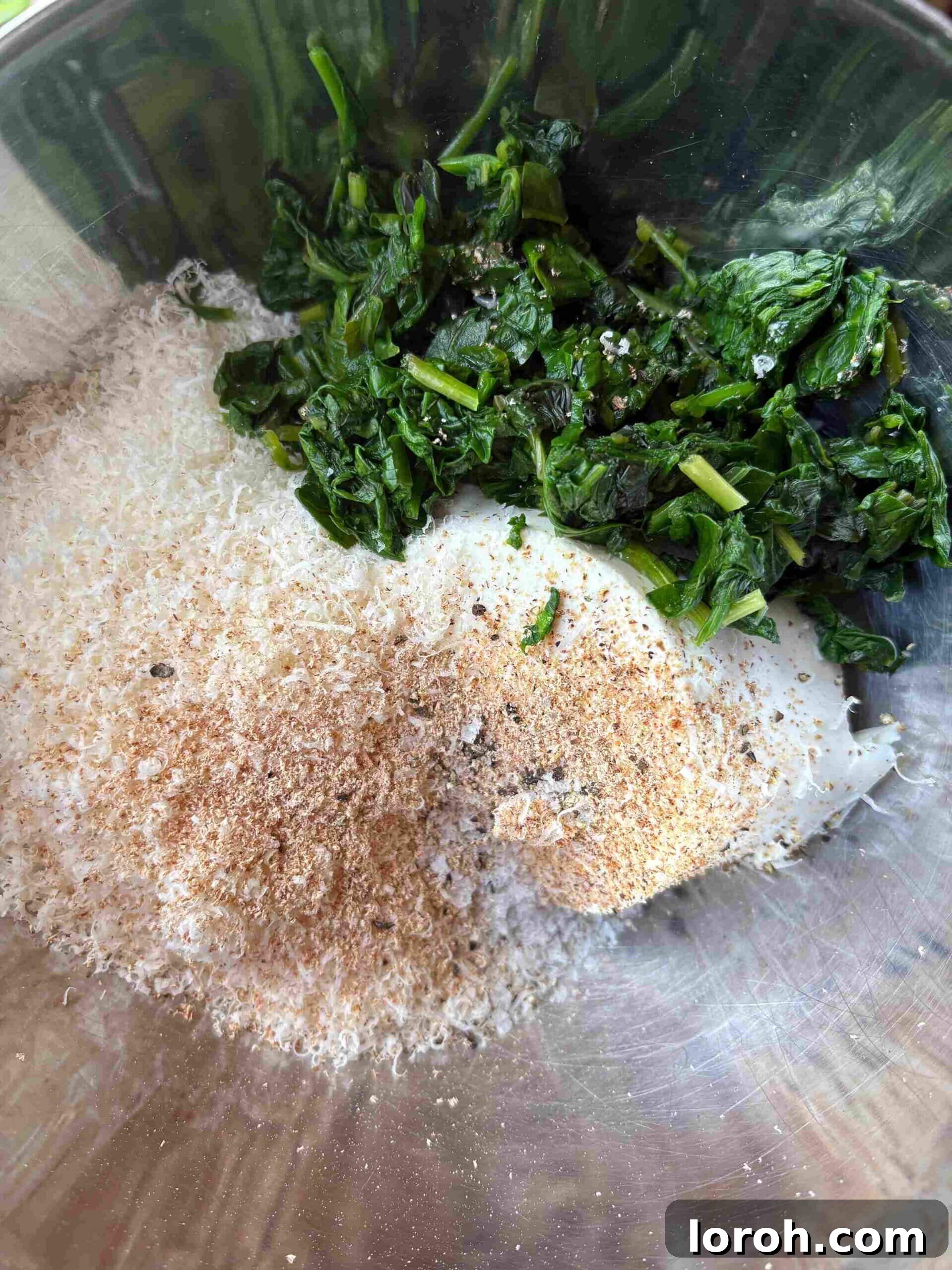 Crafting Delicious Triangoli Pasta From Scratch 5 Spinach and ricotta filling being prepared in a bowl.