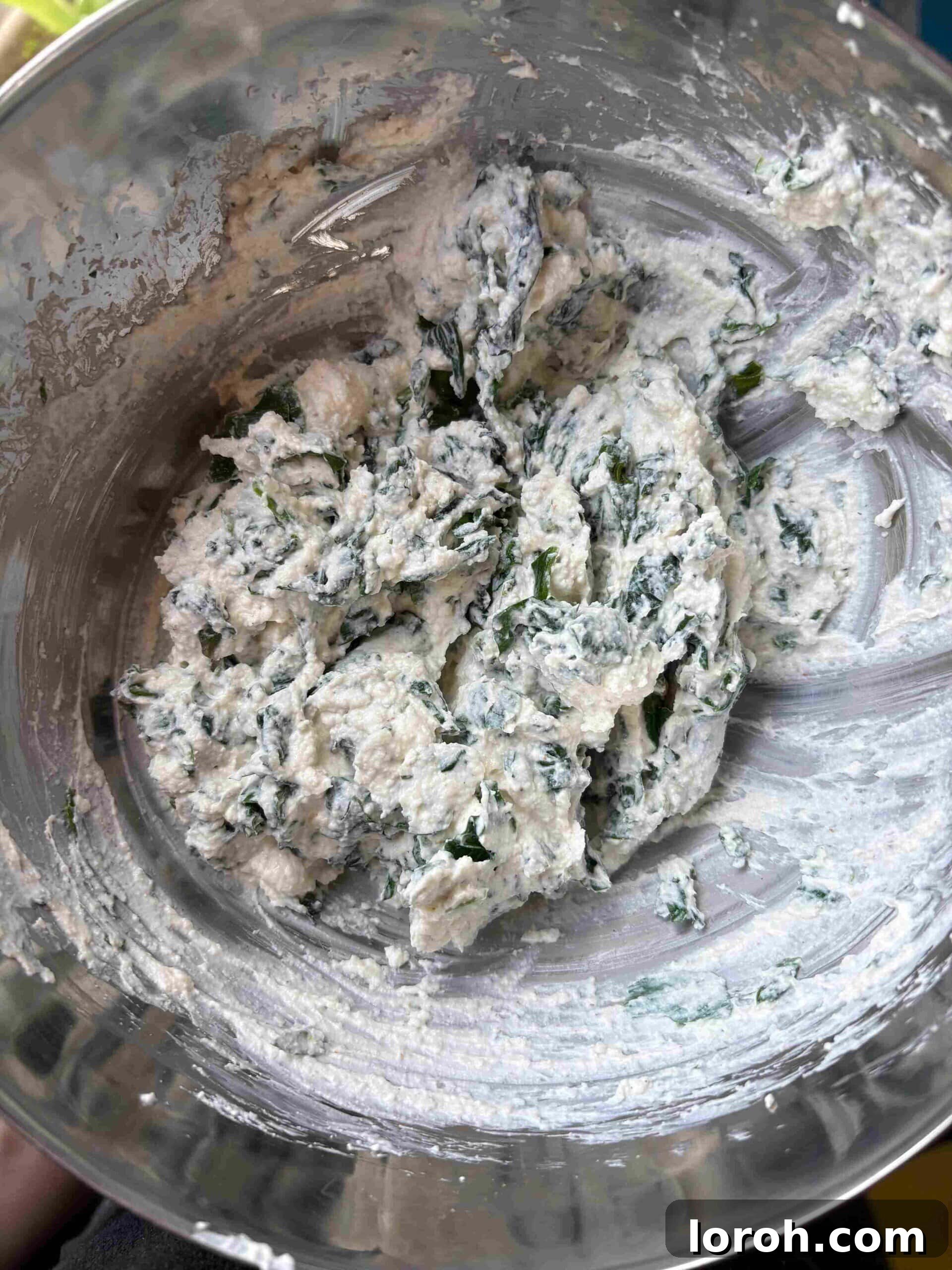 Crafting Delicious Triangoli Pasta From Scratch 6 Mixing spinach and ricotta filling in a bowl.