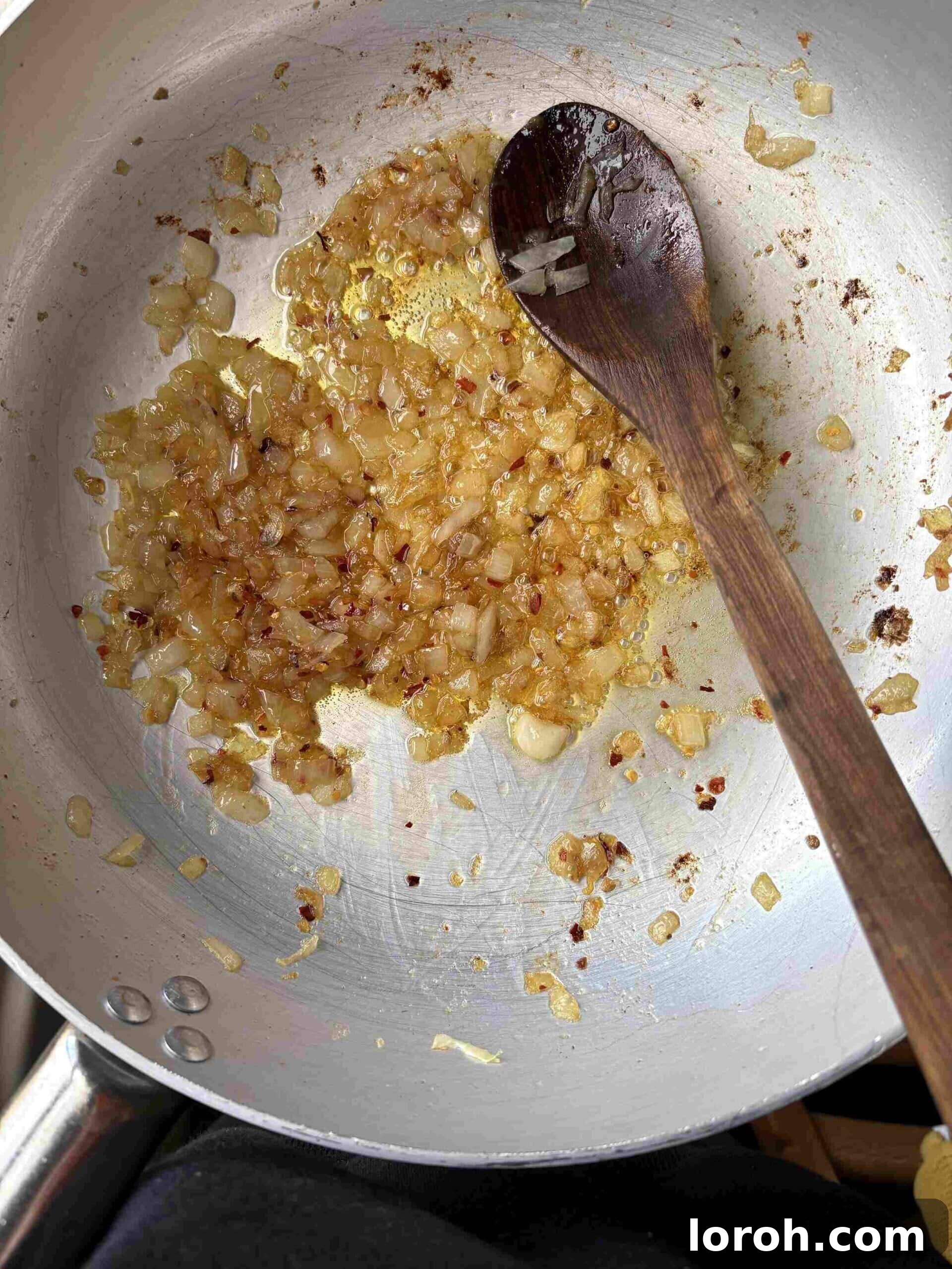 Guanciale Tomato Penne 6 Finely diced onions gently frying in the rendered guanciale fat with olive oil, softening in the pan.
