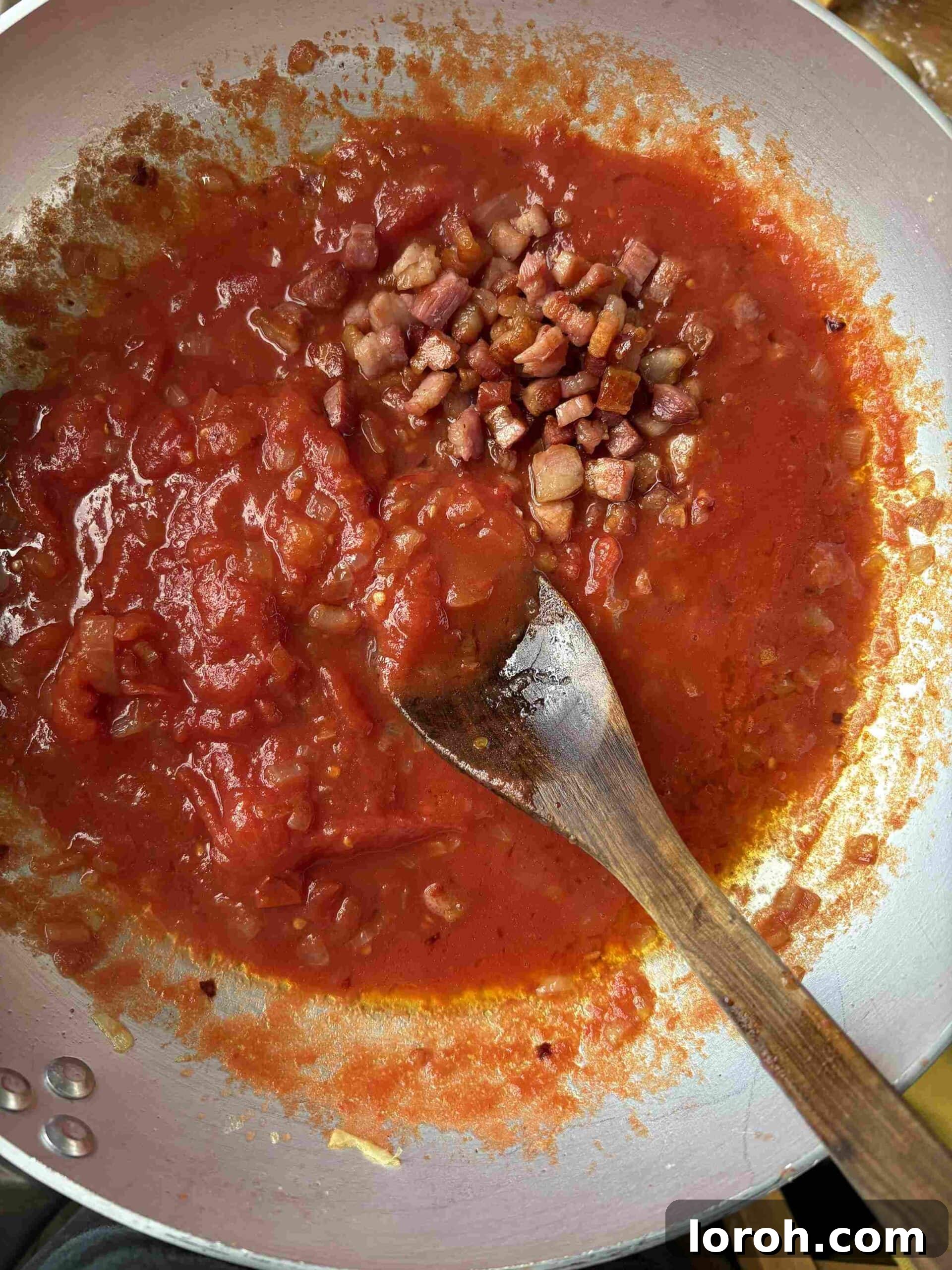 Guanciale Tomato Penne 8 The Penne Amatriciana sauce simmering gently on the stove, thickening and reducing to perfection.