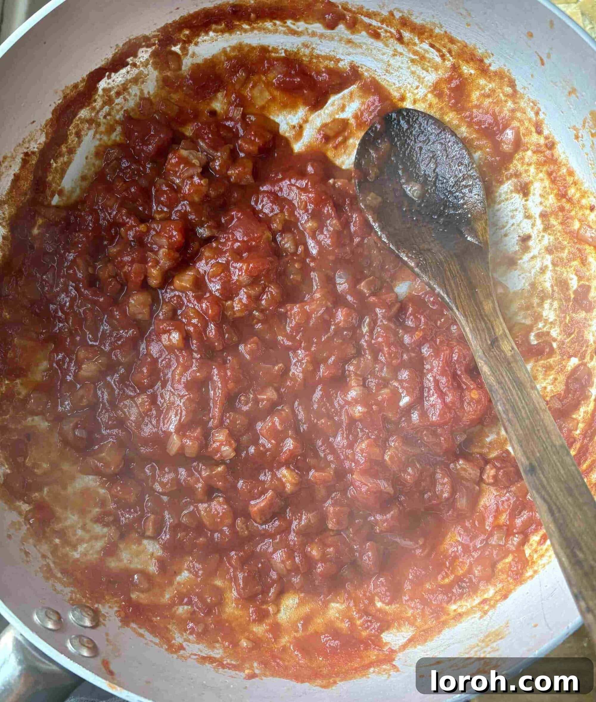 Guanciale Tomato Penne 9 A close-up of the rich Amatriciana sauce simmering gently, demonstrating its ideal consistency before adding pasta.