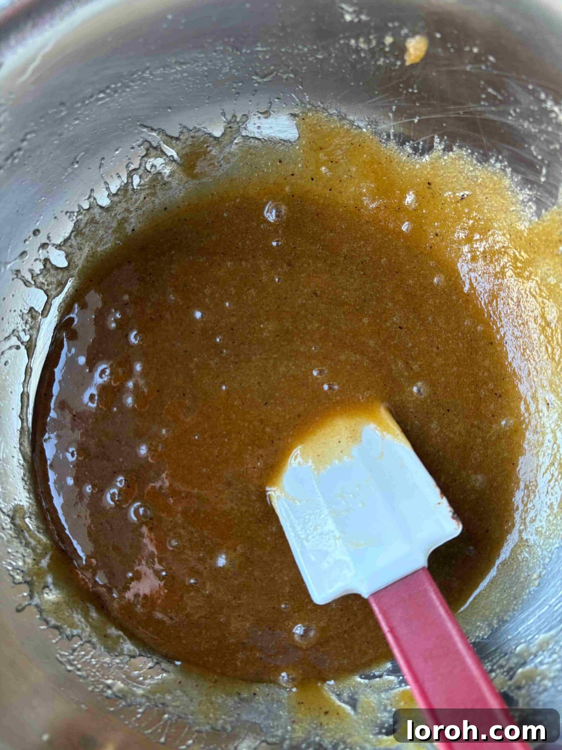 Ultimate Chocolate Chip Cookie Bars 11 Adding eggs to the butter and sugar mixture.