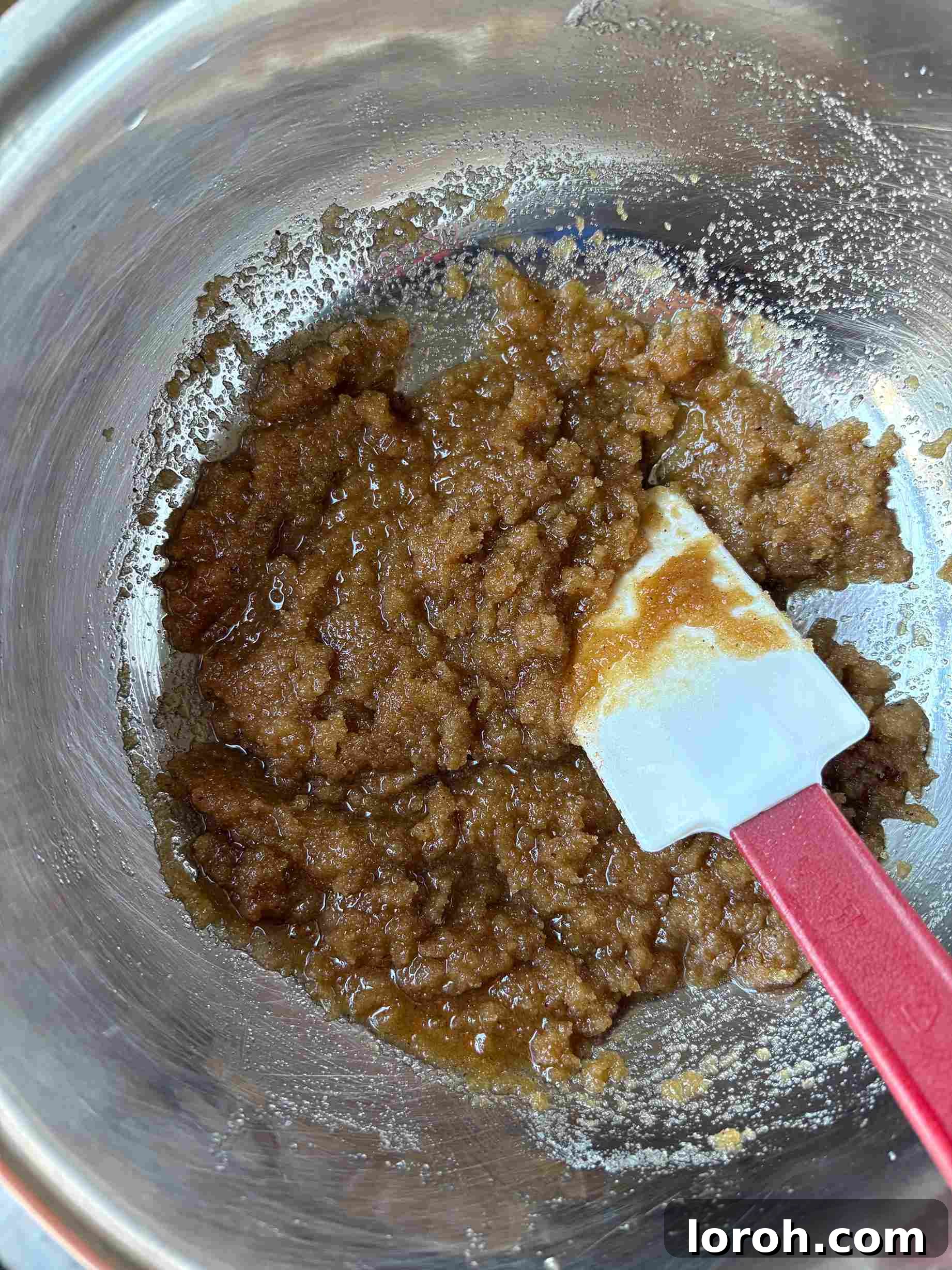 Ultimate Chocolate Chip Cookie Bars 10 Mixing sugars into brown butter in a bowl.