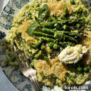 Creamy Asparagus Risotto with peas on a blue plate, ready to be served.