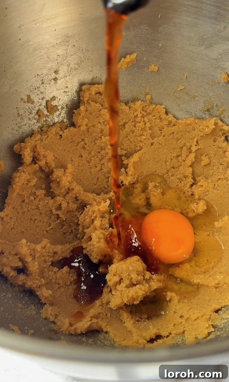 Speckled Egg Delights 5 adding egg and vanilla extract to the creamed butter and sugar mixture.