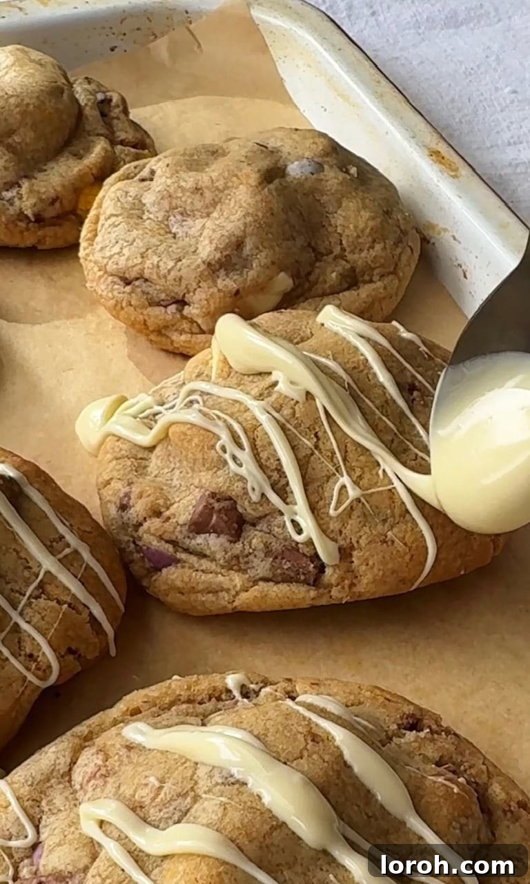 Speckled Egg Delights 9 drizzling melted white chocolate on baked mini egg cookies.