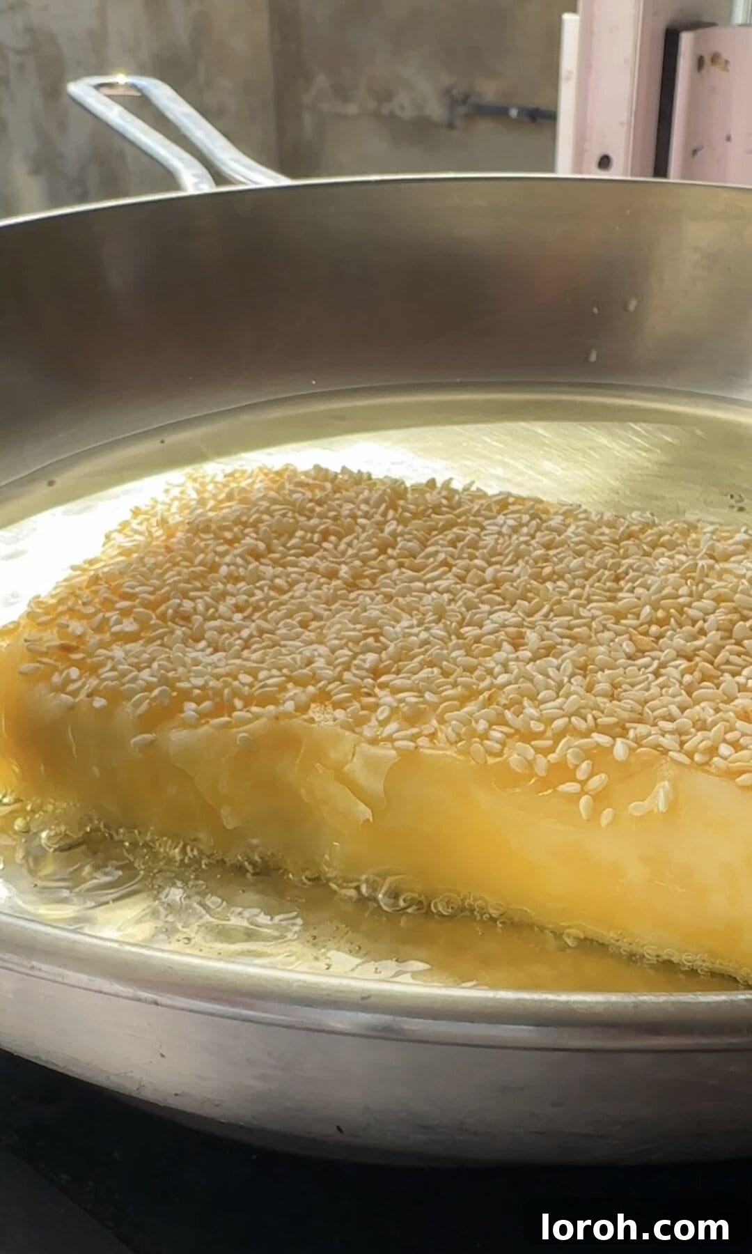 Flaming Feta Saganaki 11 Frying the feta saganaki parcel in a pan with bubbling sunflower oil