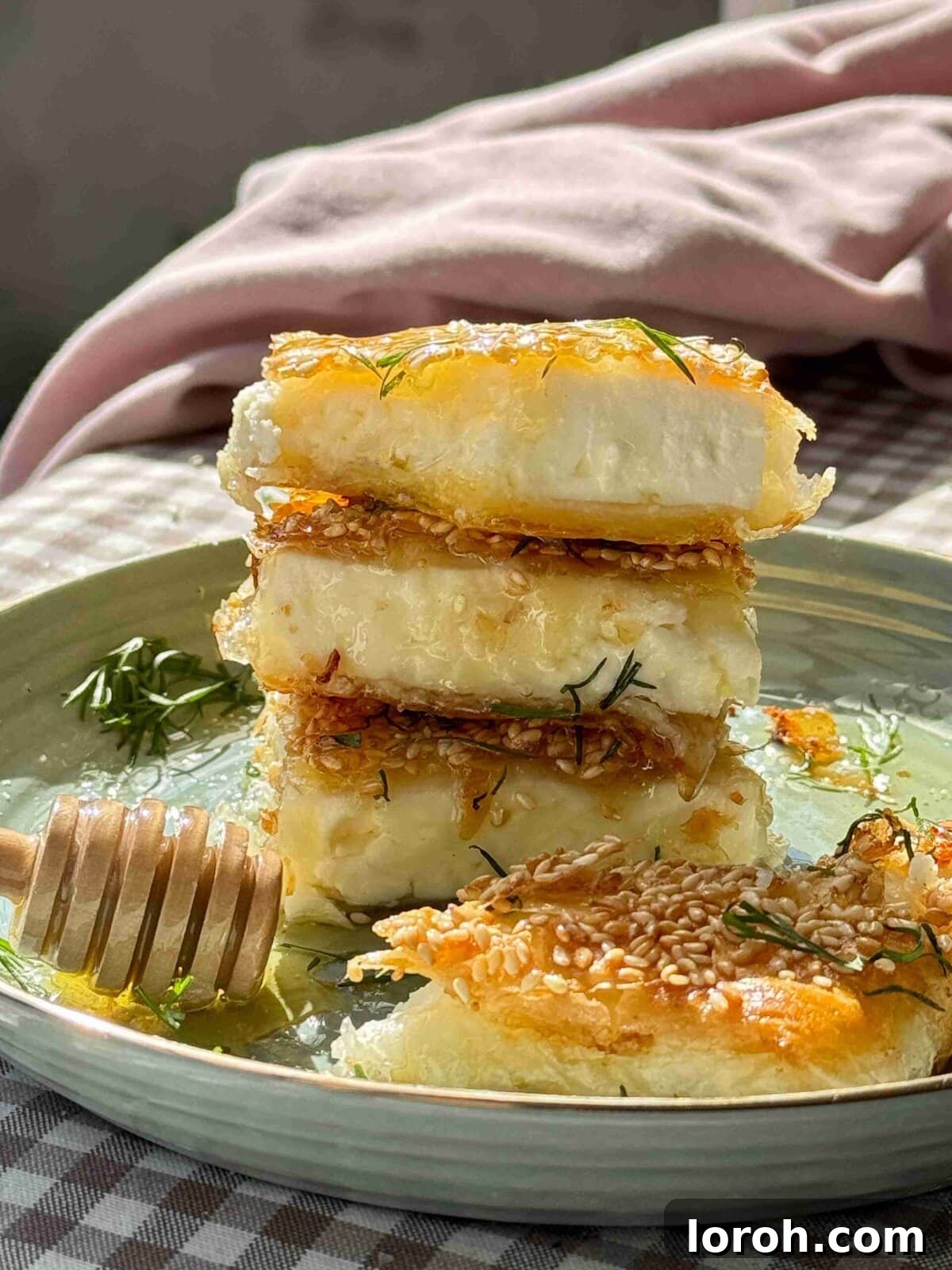Flaming Feta Saganaki 3 Crispy Feta Saganaki cut in half, showcasing the creamy feta inside and the golden filo pastry