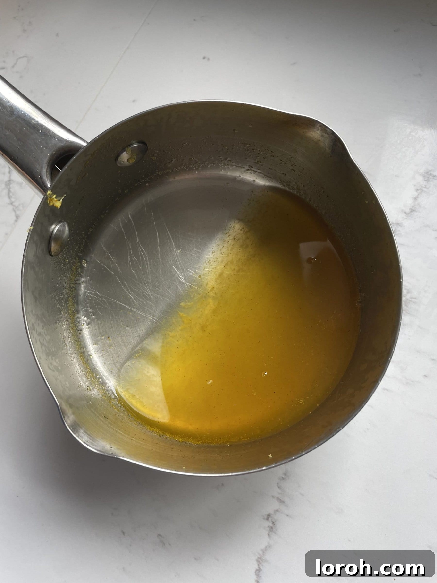 The finished fragrant citrus syrup, ready to be drizzled over the baked cake.
