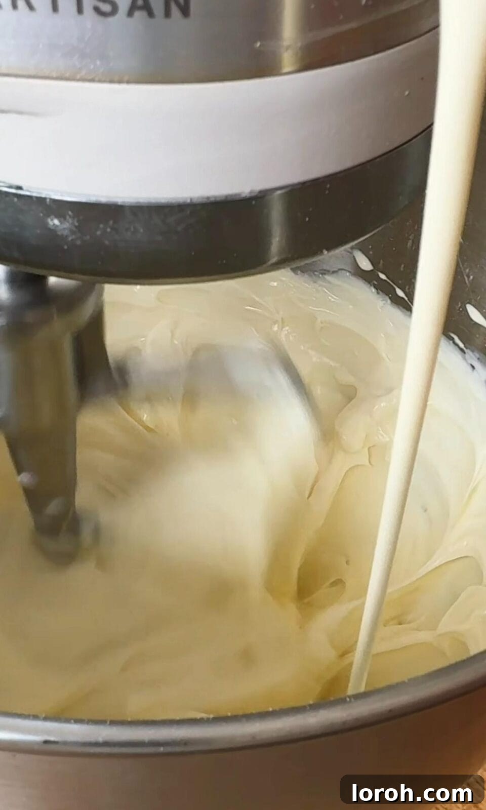 Making the creamy, tangy cream cheese frosting for the berry cake.