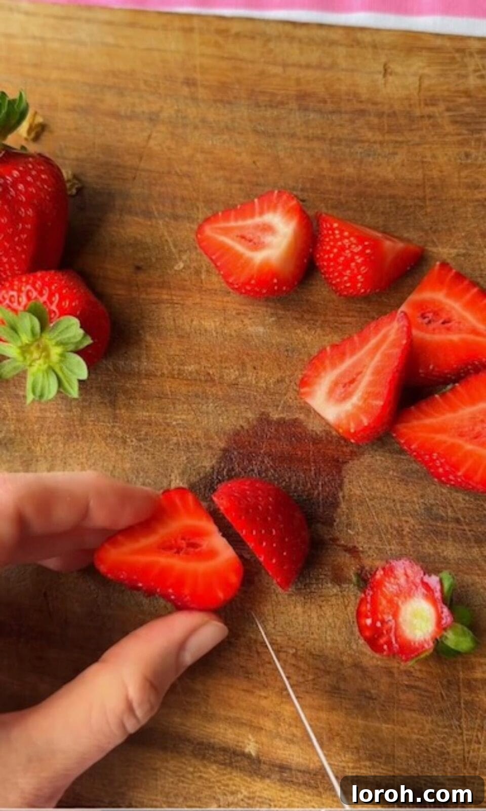 Slicing fresh strawberries for the Dubai chocolate strawberry dessert.